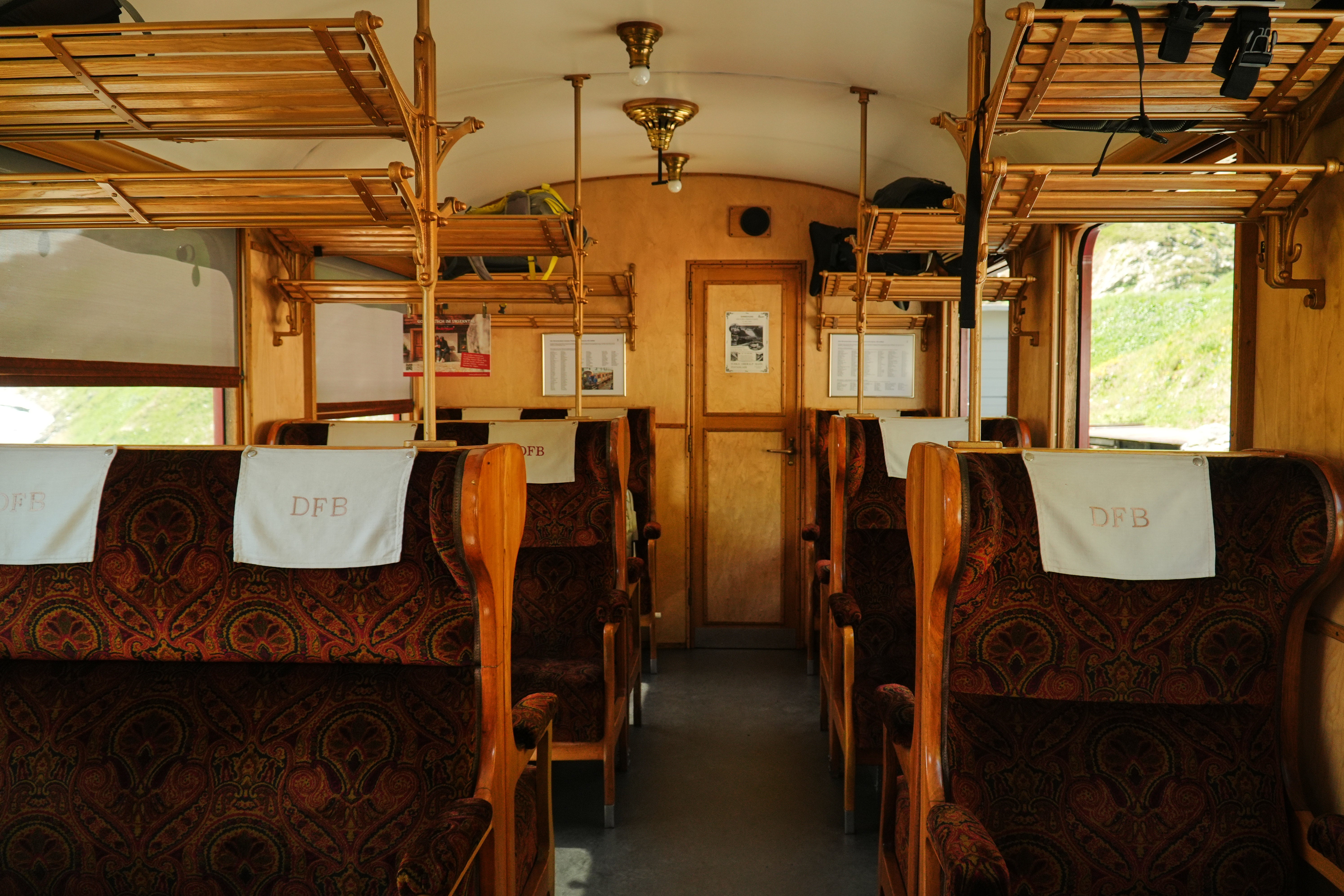 Interior view of a historic passenger carriage in service on the Furka railway.