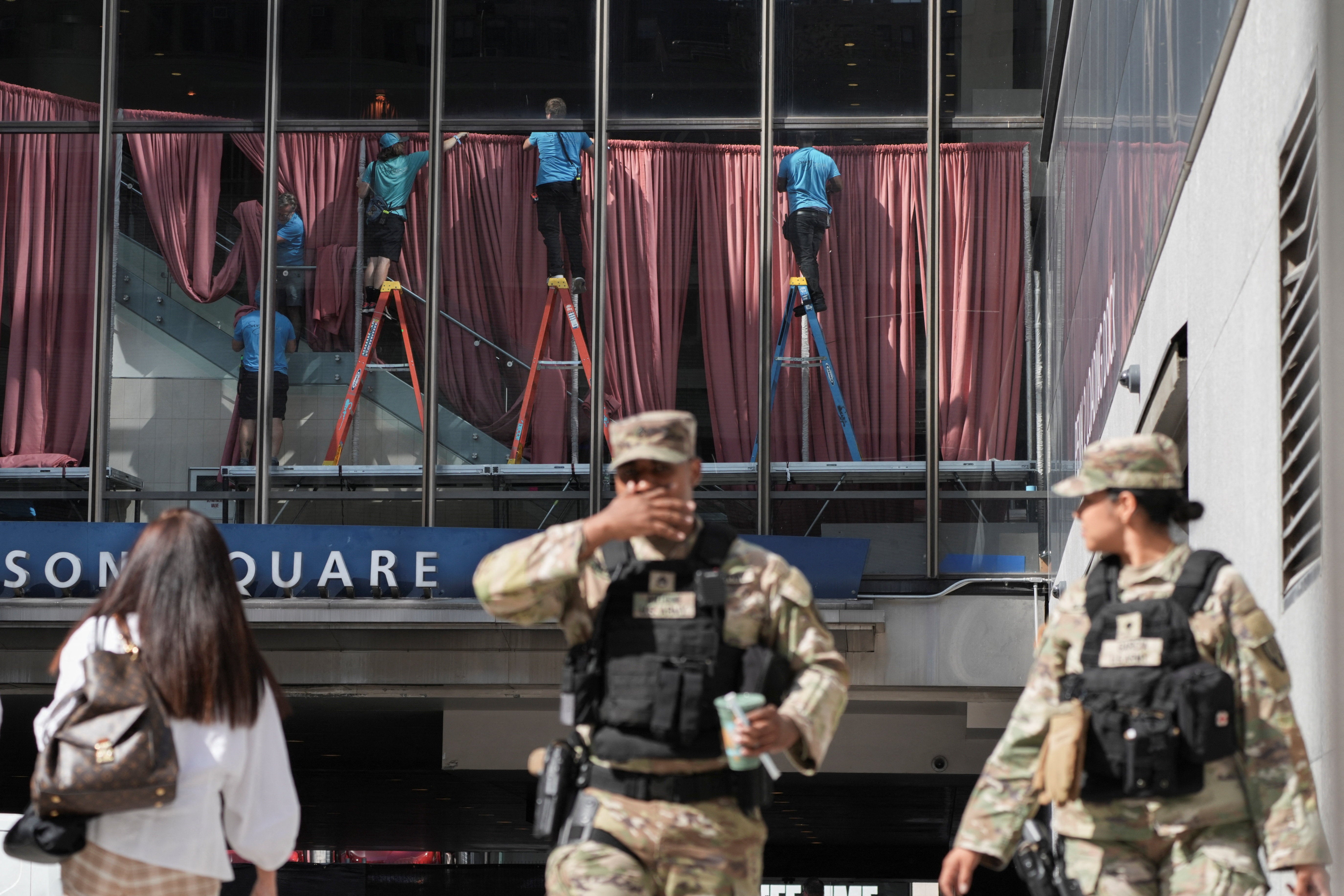 Workers operate inside Madison Square Garden, ahead of a reported wedding Taylor Swift and Travis Kelce wedding, as members of the Armed Forces stand outside in New York City (Reuters)