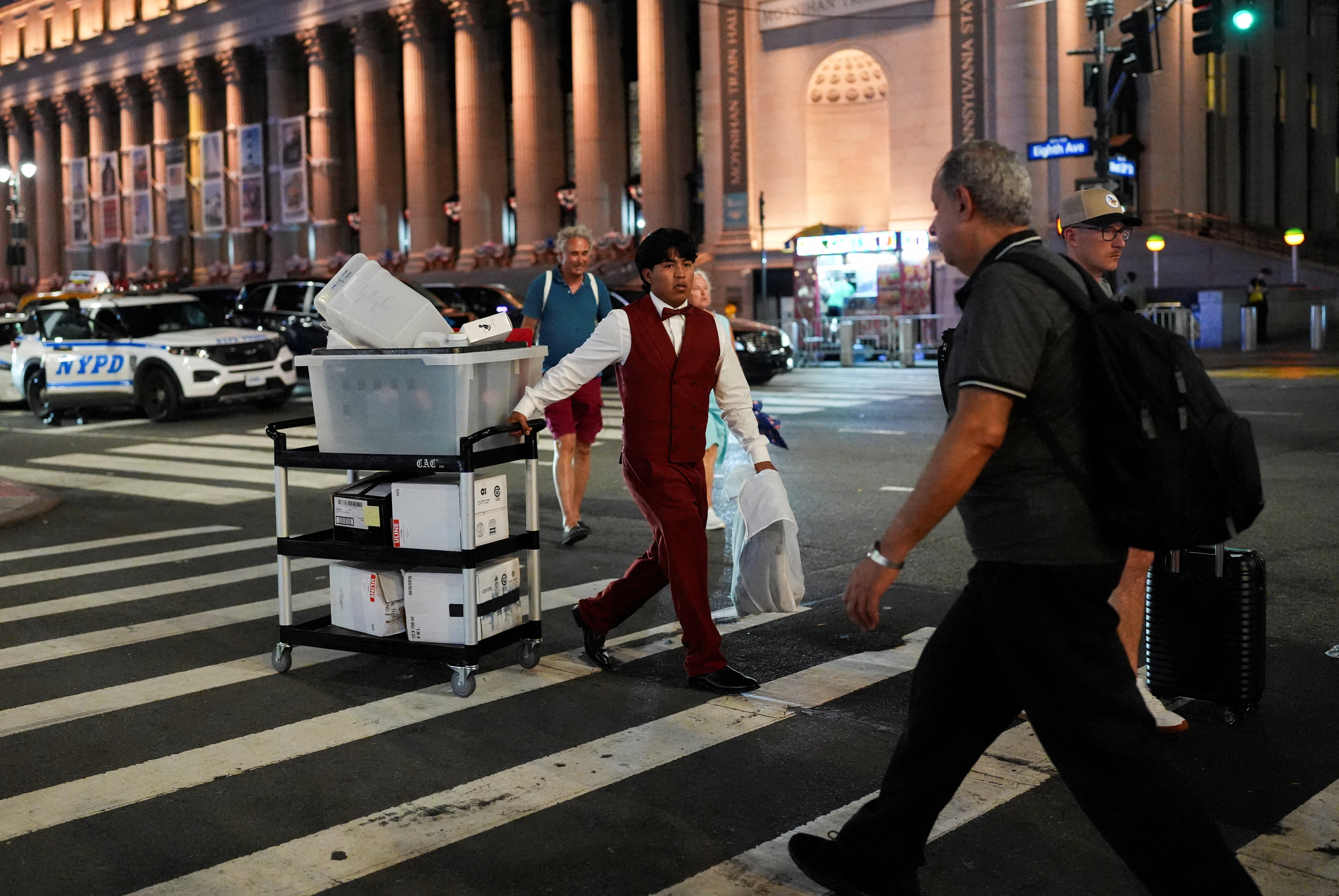 A worker believed to be a part of the reported Taylor Swift-Travis Kelce wedding crosses a road outside Madison Square Garden (Reuters)