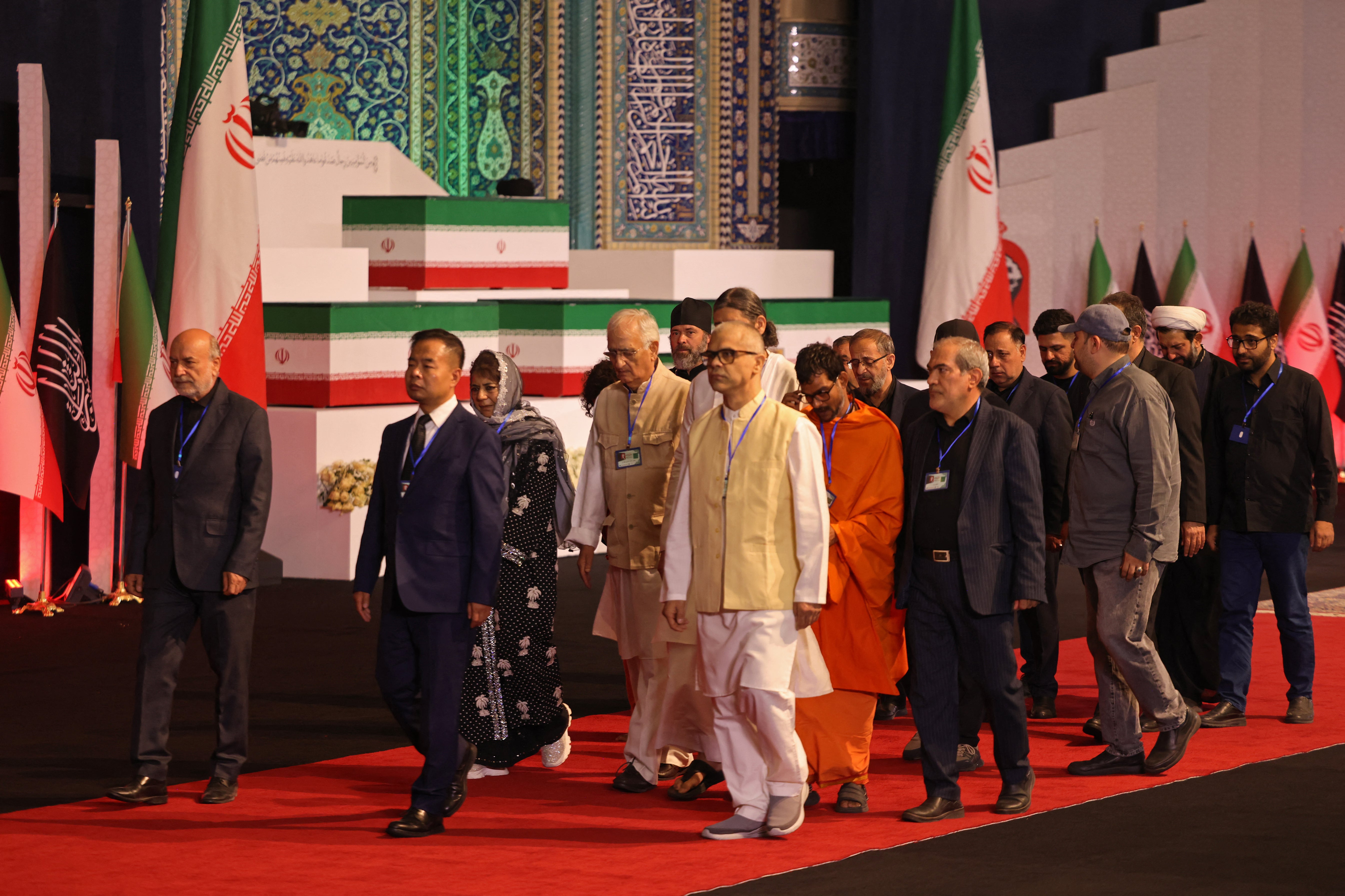 Members of Indian delegation walk past the coffins of Iran's slain supreme leader Ali Khamenei and his family members after paying their respects at the Grand Mosalla in Tehran (AFP/Getty)