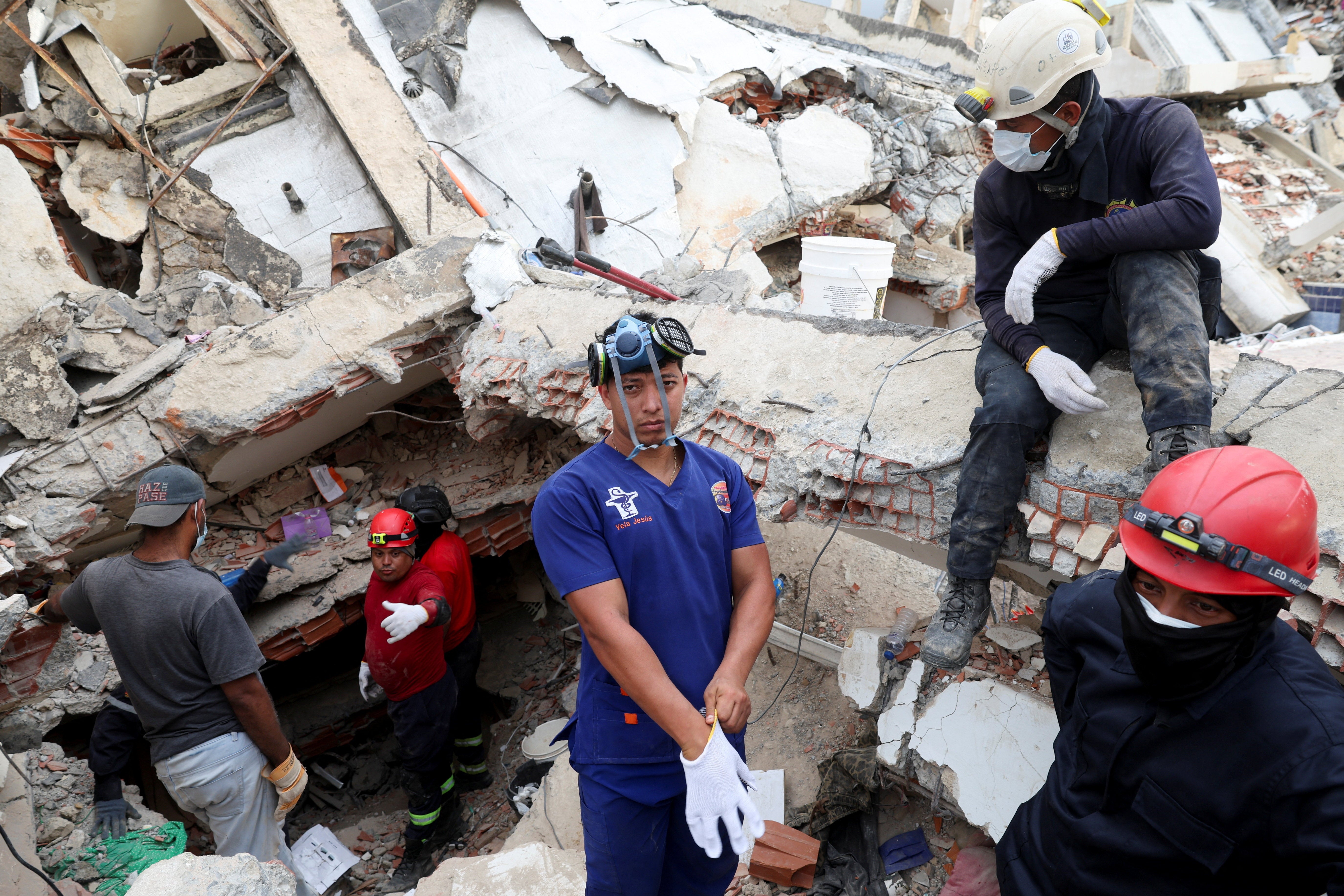 Rescuers work at the site of a collapsed building, in the aftermath of earthquakes, in La Guaira (Reuters)