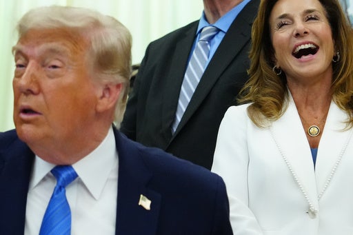 Rep. Lisa McClain, R-Mich., chair of the House Republican Conference, laughs as President Donald Trump speaks in the Oval Office of the White House, Wednesday, June 10