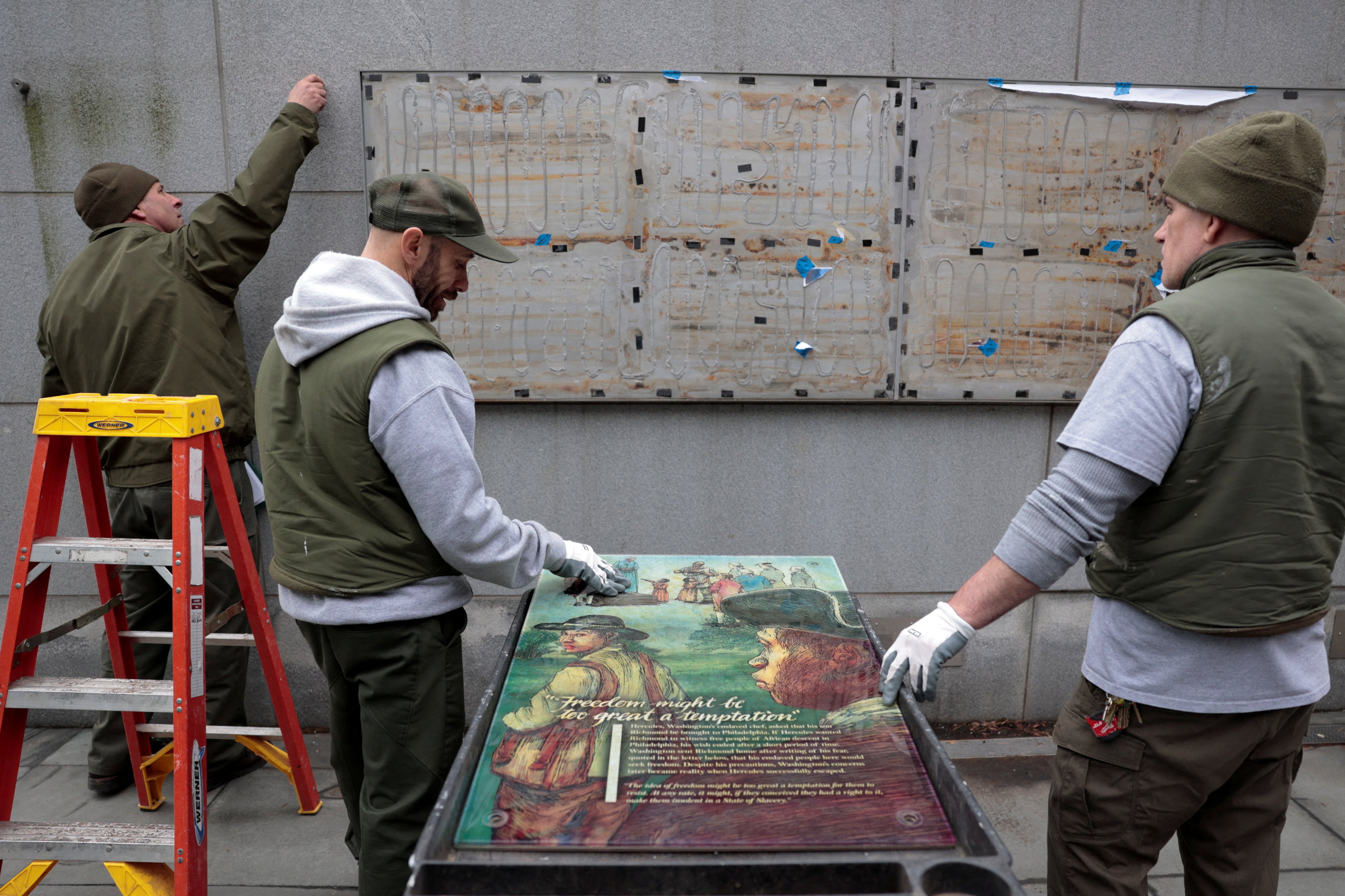 Workers from the National Park Service reinstall a slavery exhibit at a historic site in Philadelphia, following a U.S. judge order to reinstall, in Pennsylvania
