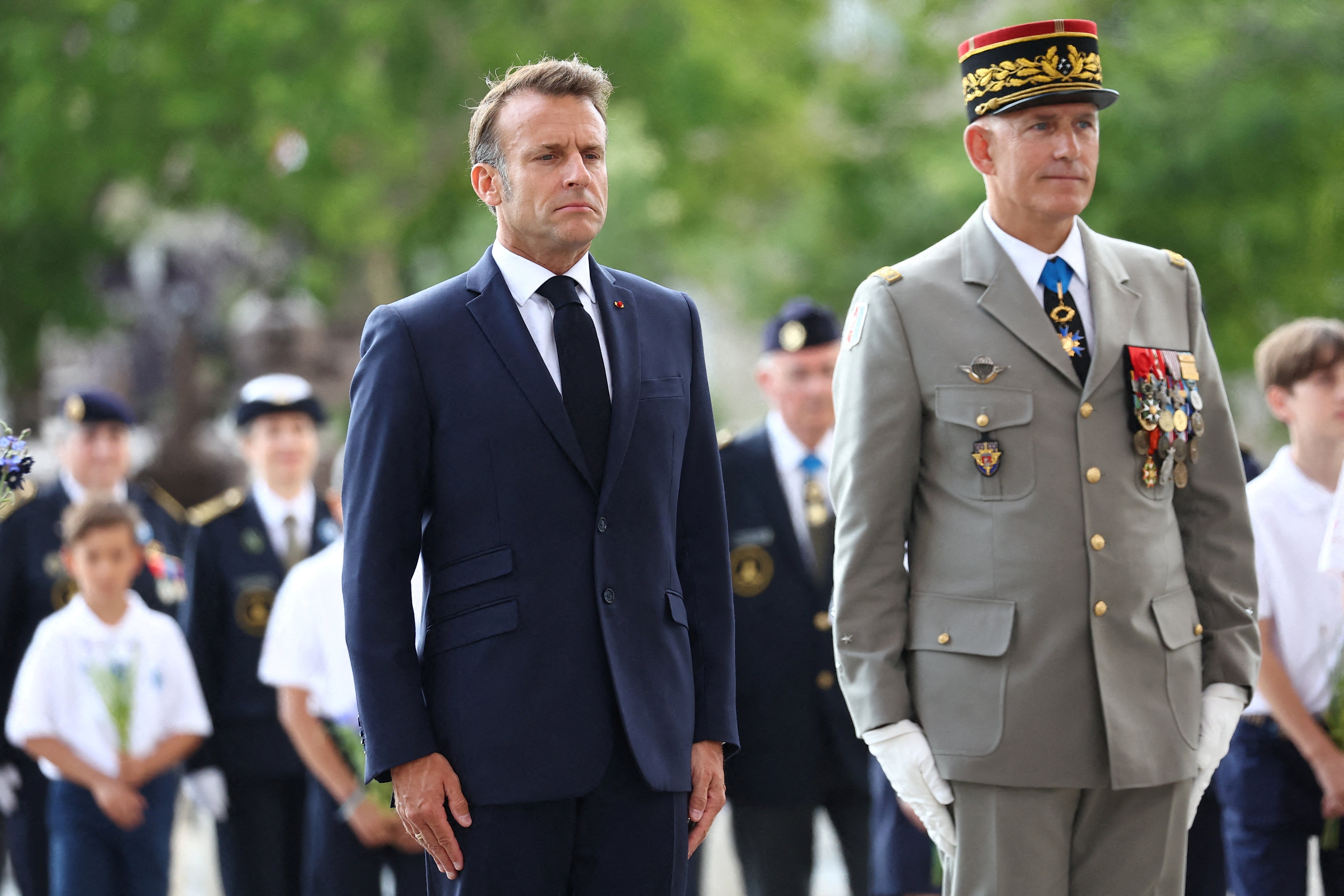 French President Emmanuel Macron and Military Governor of Paris Loic Mizon attend a ceremony to celebrate the 100th anniversary of the association "The Flame under the Arc de Triomphe, Flame of the Nation."