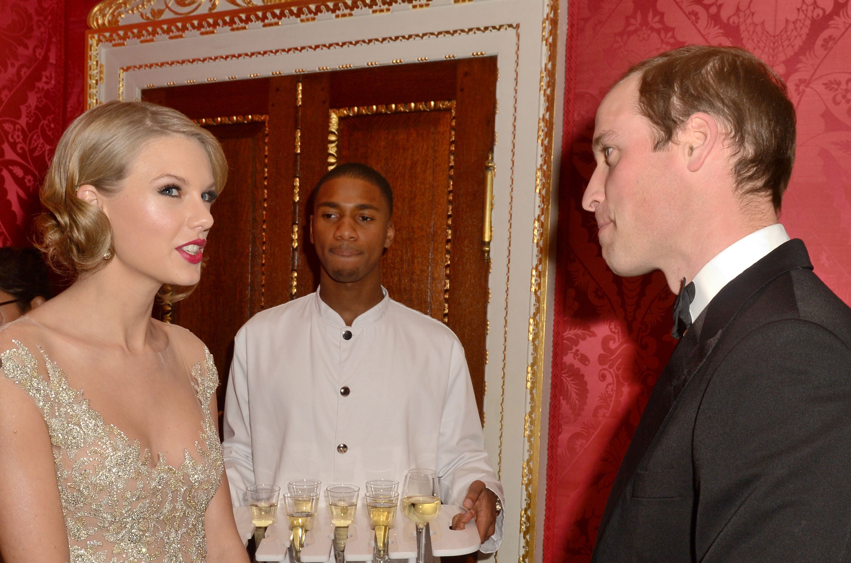 William and Swift chatted at a gala for the Centrepoint charity at Kensington Palace in 2013 (PA)
