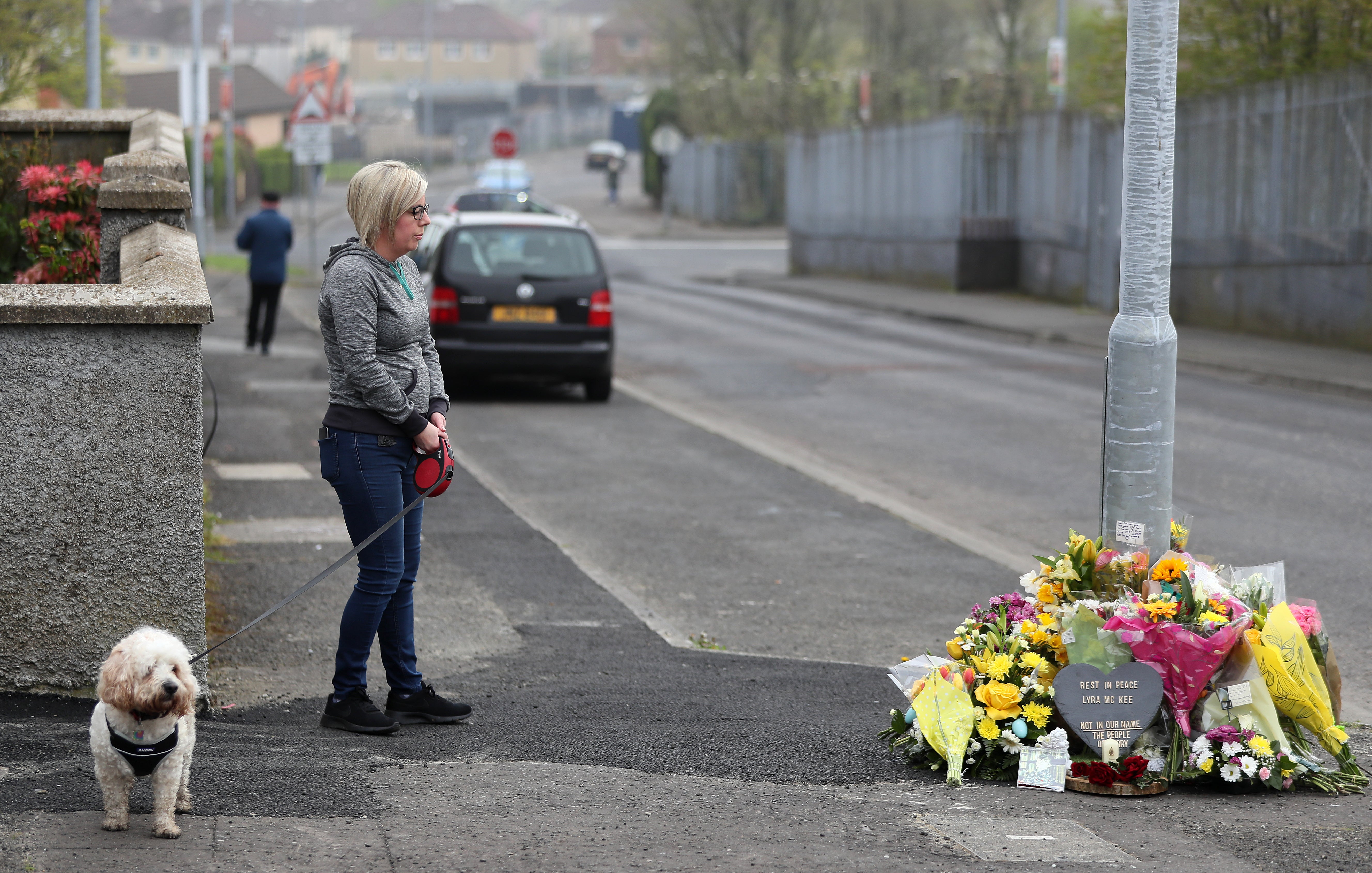 A woman stops to pay her respects at the scene on Fanad Drive, Derry, where 29-year-old journalist Lyra McKee was shot