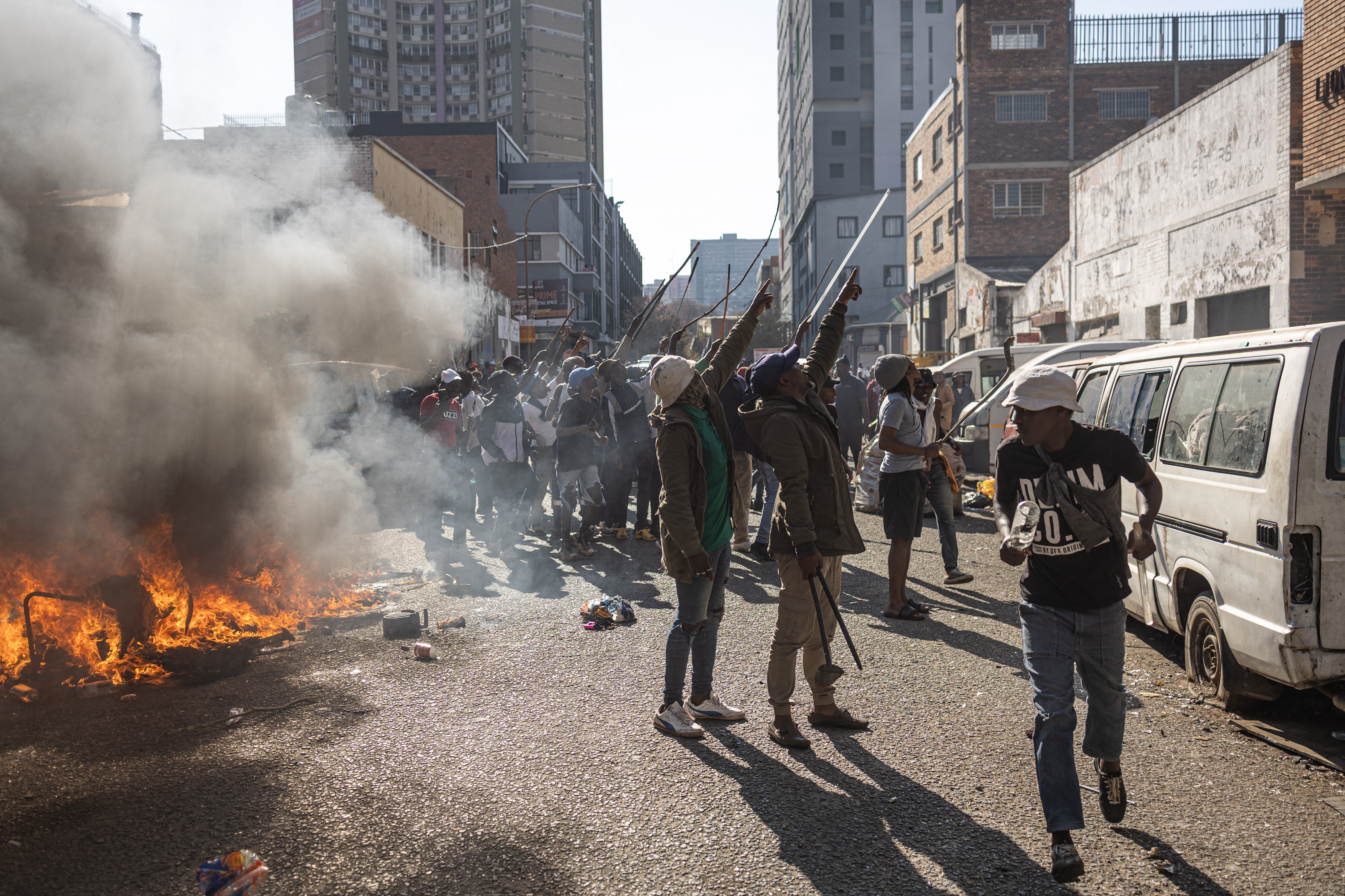 Protesters have targeted foreign nationals, and in this picture are seen gesturing towards people they believe to be undocumented foreigners