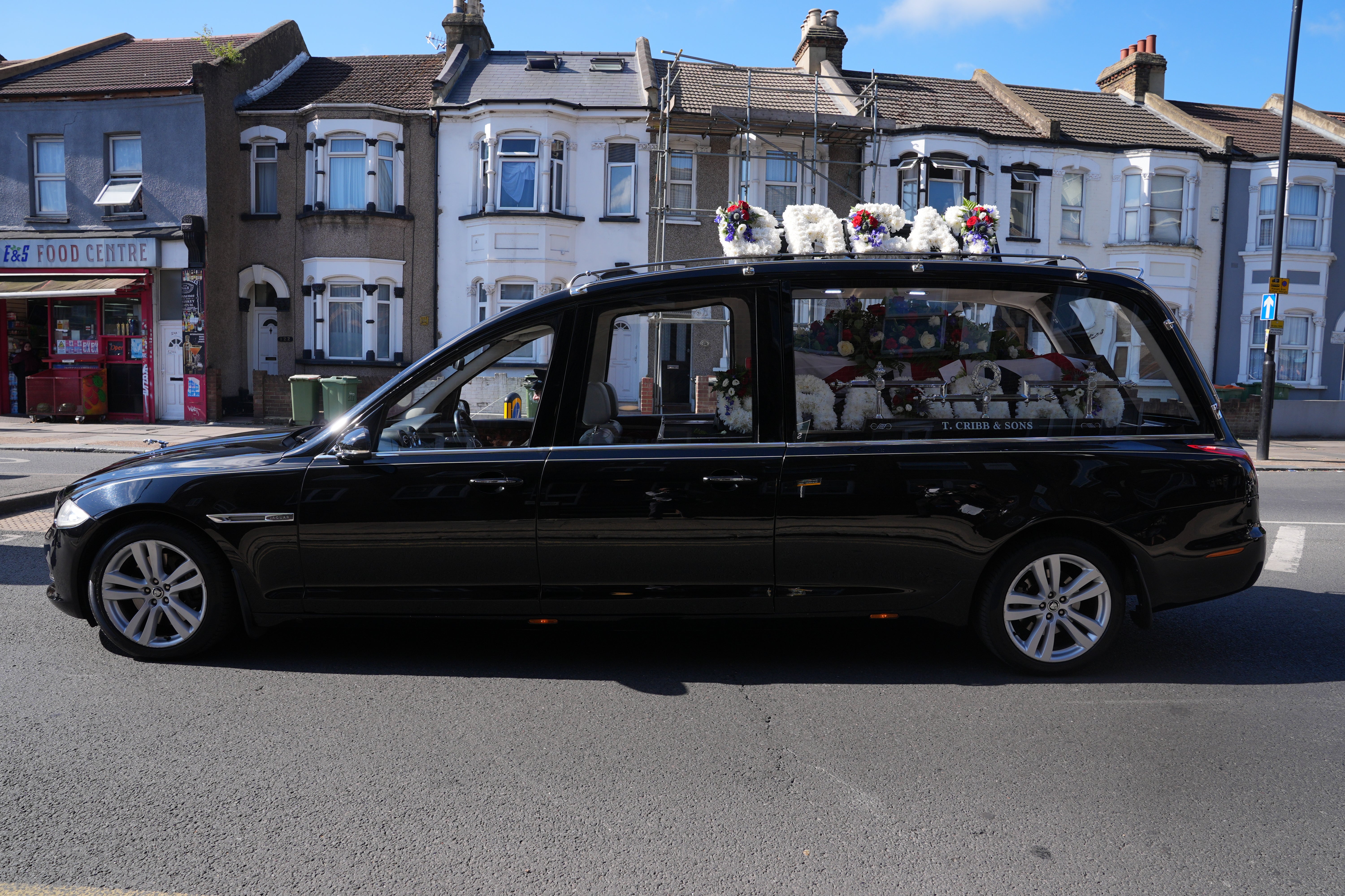 The hearse makes its way through East Ham (Yui Mok/PA) (PA Wire)