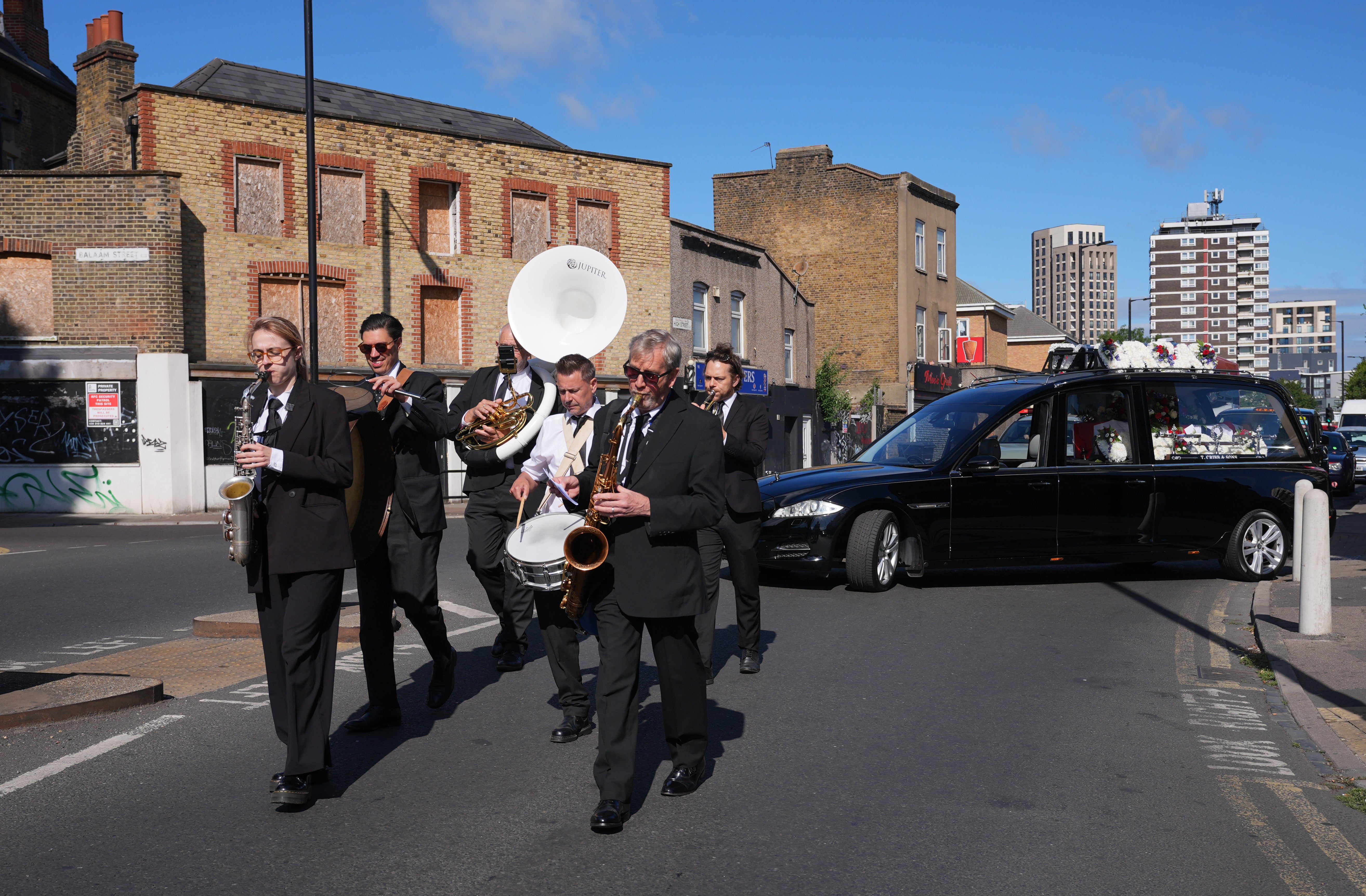 A New Orleans-style jazz band leads the cortege in East Ham for the funeral of WWII veteran Gilbert Clarke (Yui Mok/PA) (PA Wire)