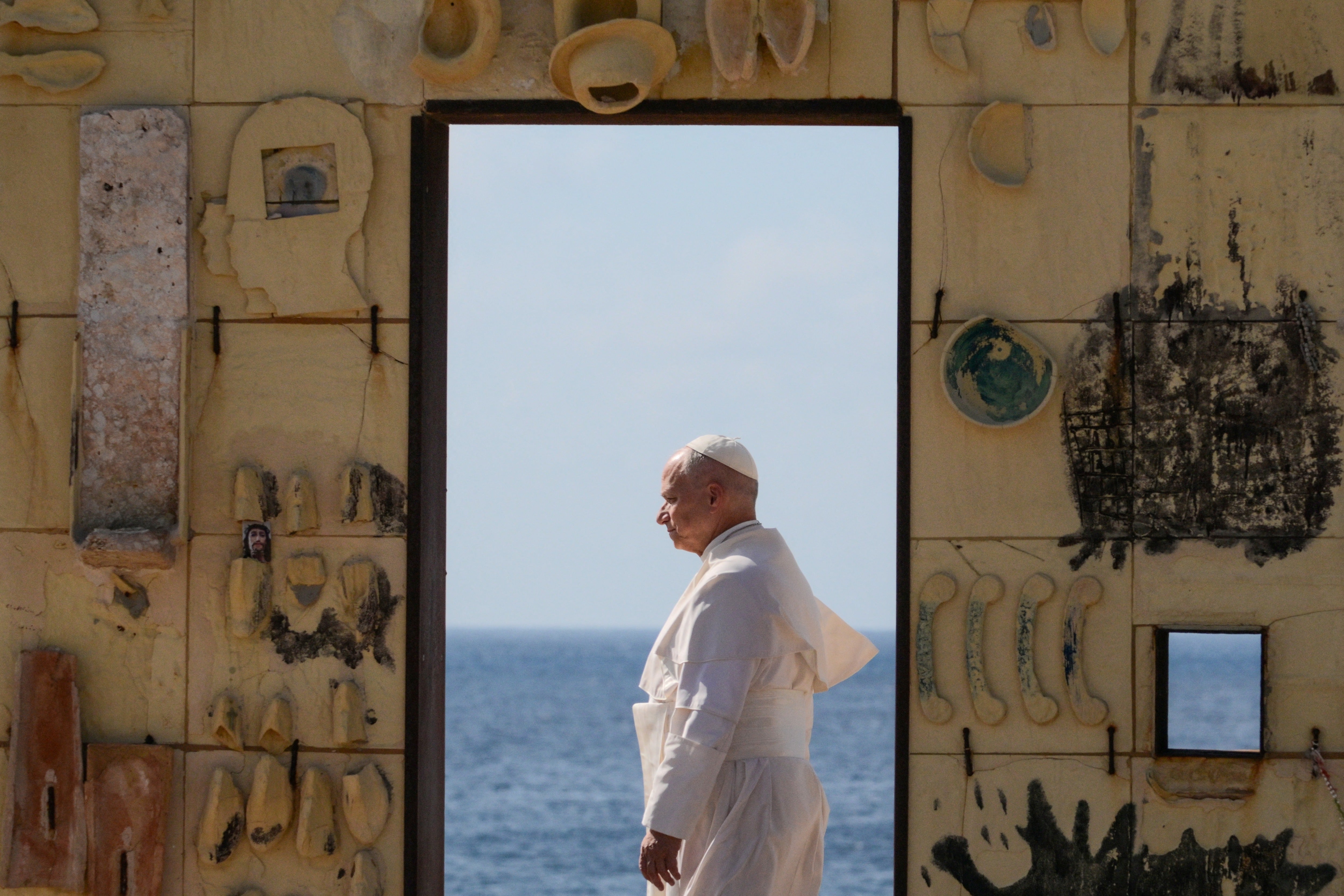Pope Leo XIV walks trough the arch of the monument Door of Europe - Porta d'Europa made by the italian artist Mimmo Paladino, during a one day visit to Lampedusa island, south of Sicily, on July 4, 2026