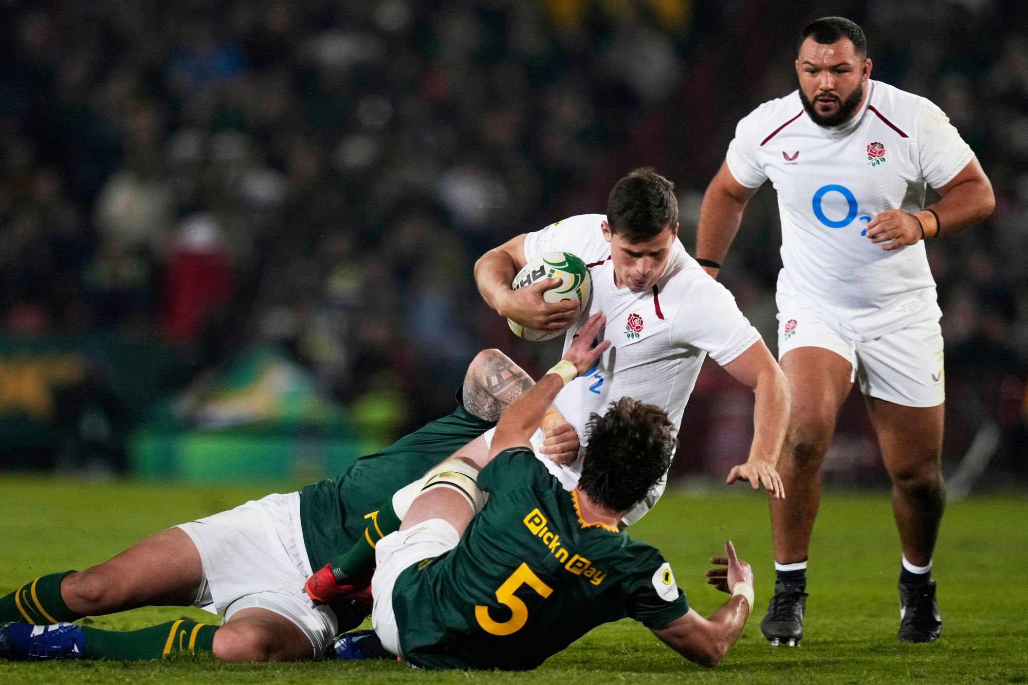 England's Seb Atkinson, center, is tacked by South Africa's Damian de Allende, back, and his teammate Ruan Nortje (AP Photo/Themba Hadebe)