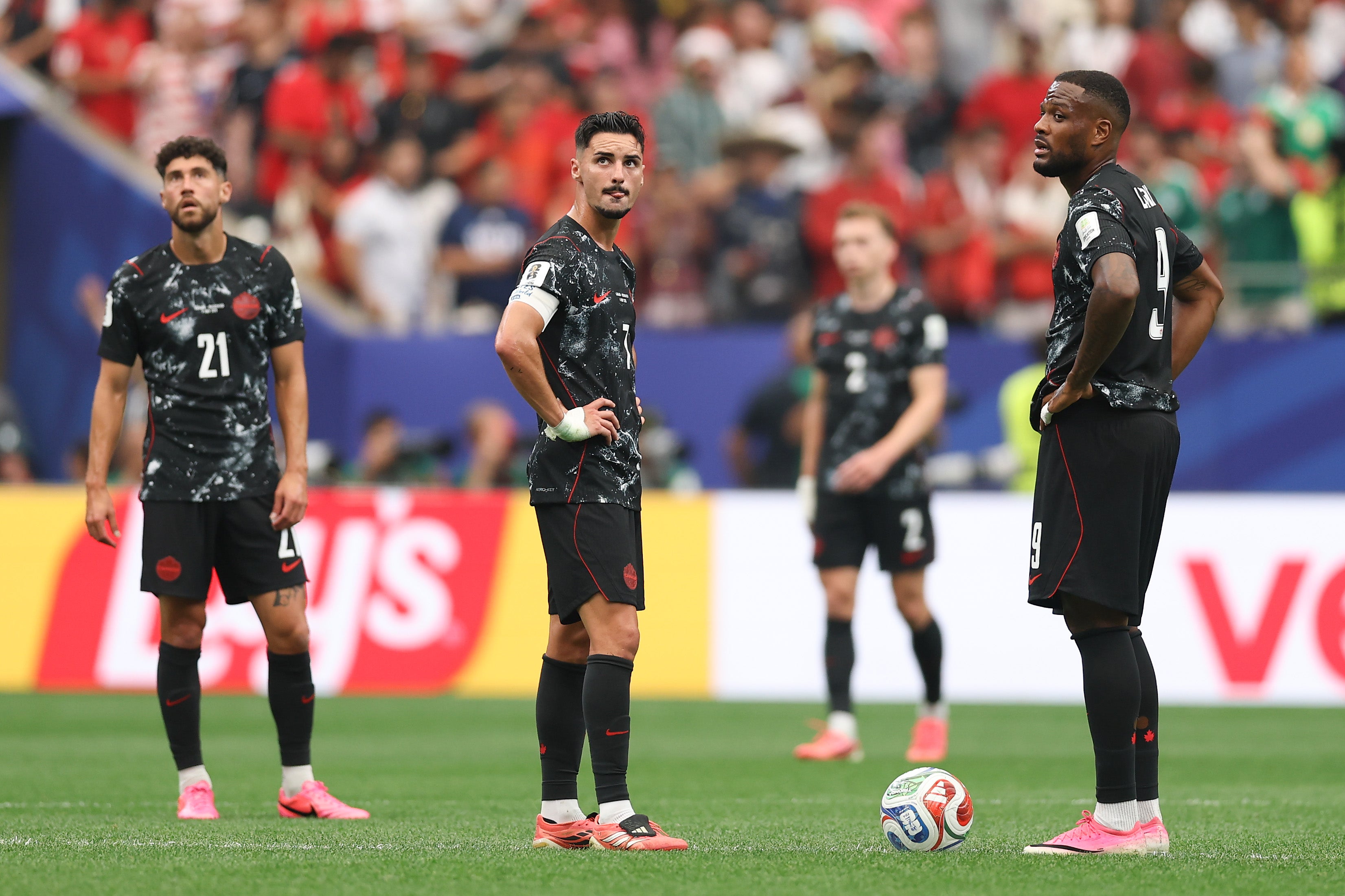 Stephen Eustaquio and Cyle Larin of Canada react after Morocco's third goal