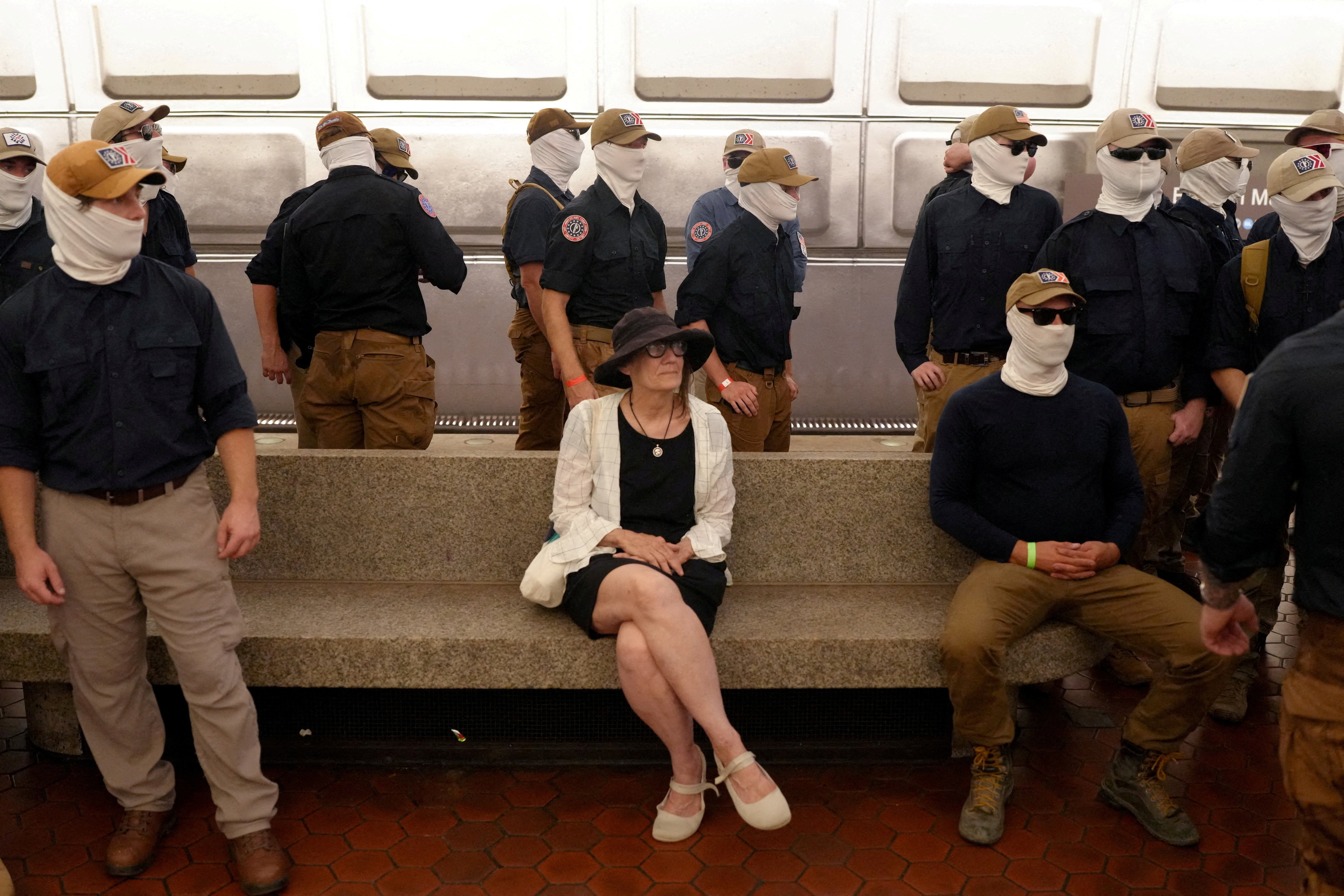 Members of the group surround a commuter at Eastern Market metro station