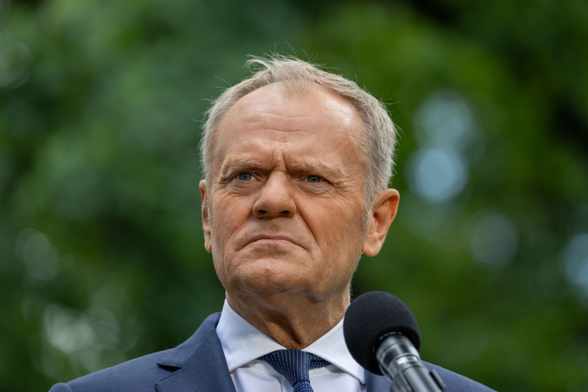 Poland's Prime Minister Donald Tusk speaks to the press during a press conference in the gardens of the Prime Minister's Chancellery building in Warsaw