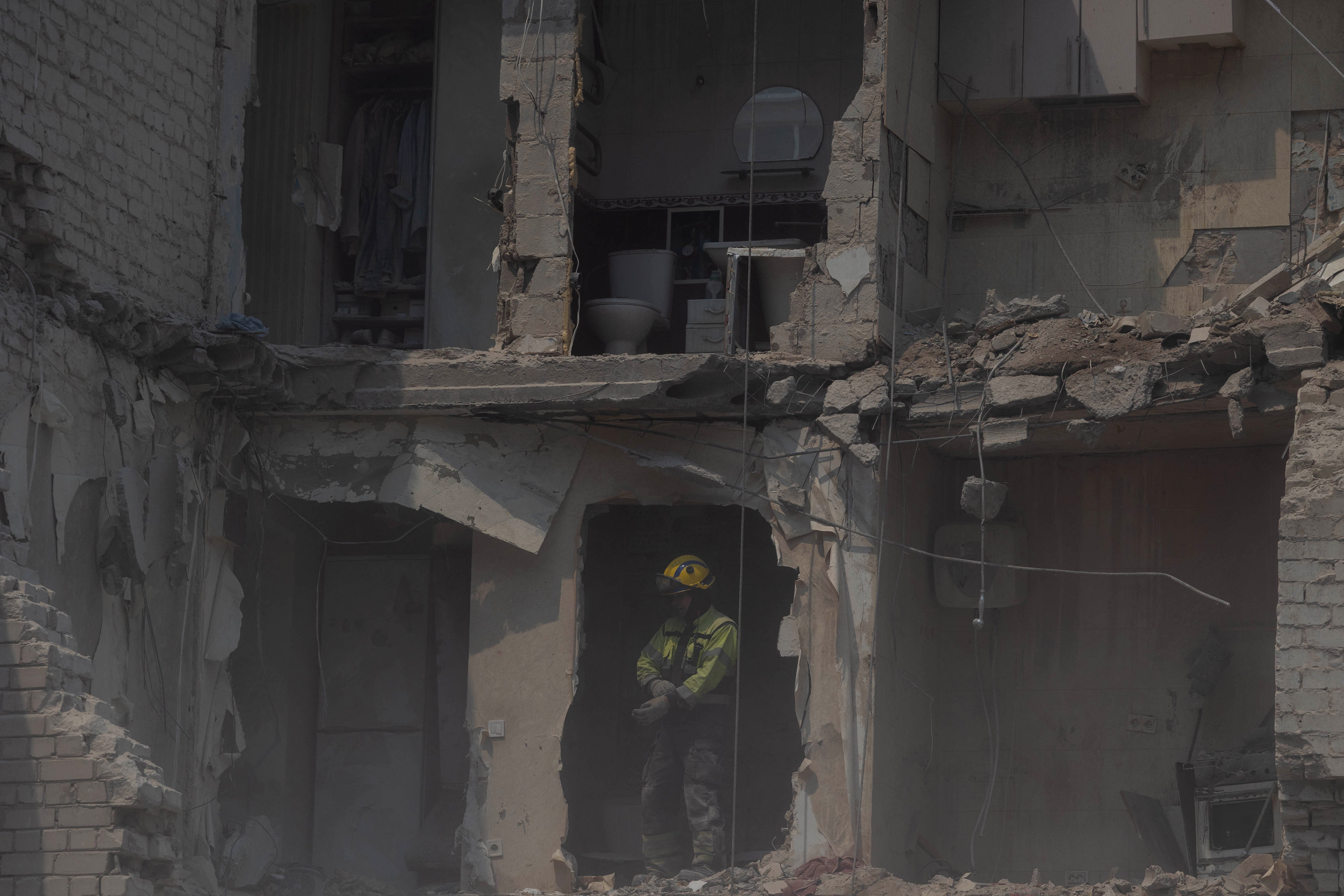 A rescue worker stands in a residential building damaged following a Russian air attack on Kyiv