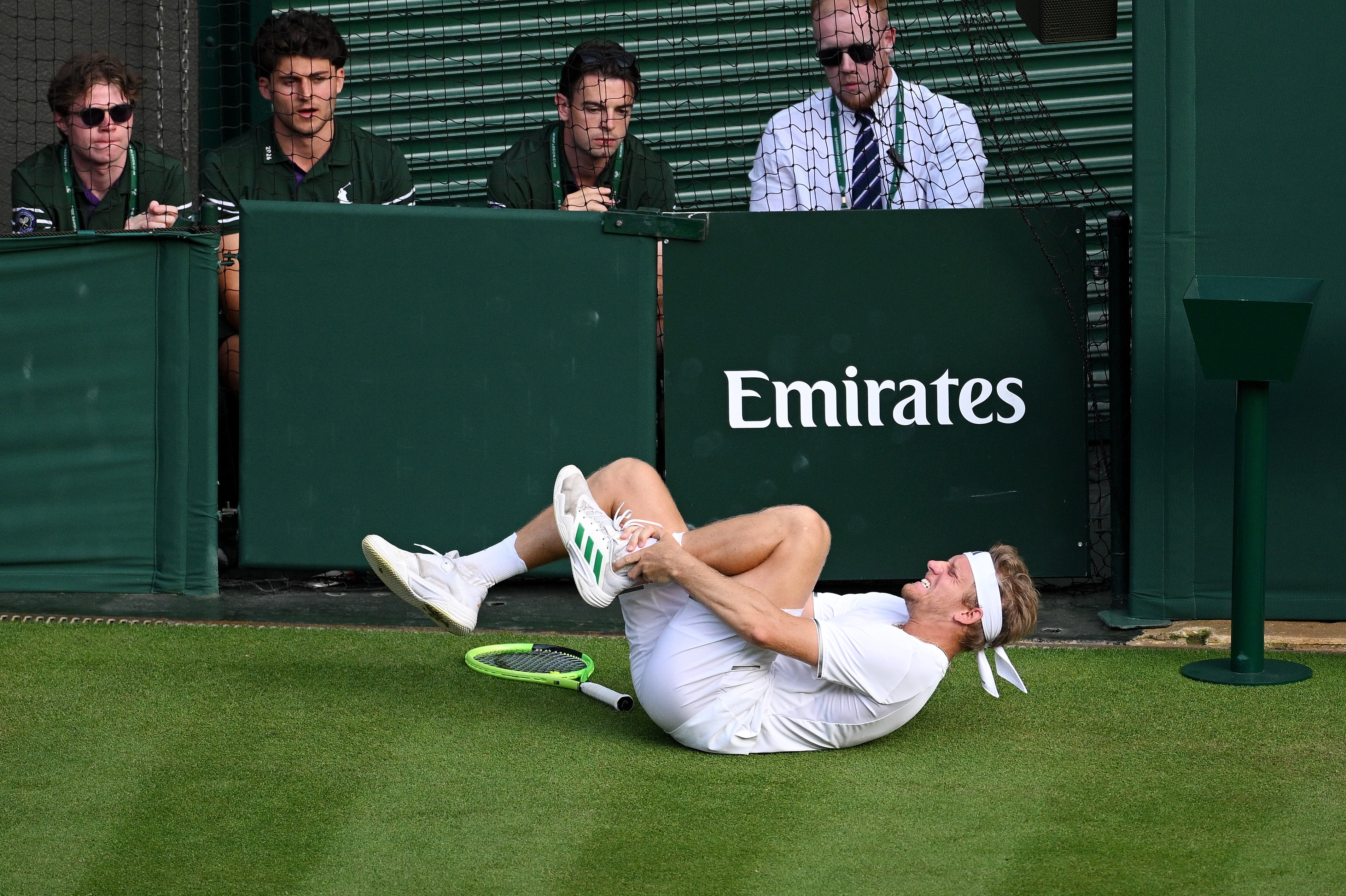 Davidovich Fokina was left clutching his ankle after sliding for the ball on the grass
