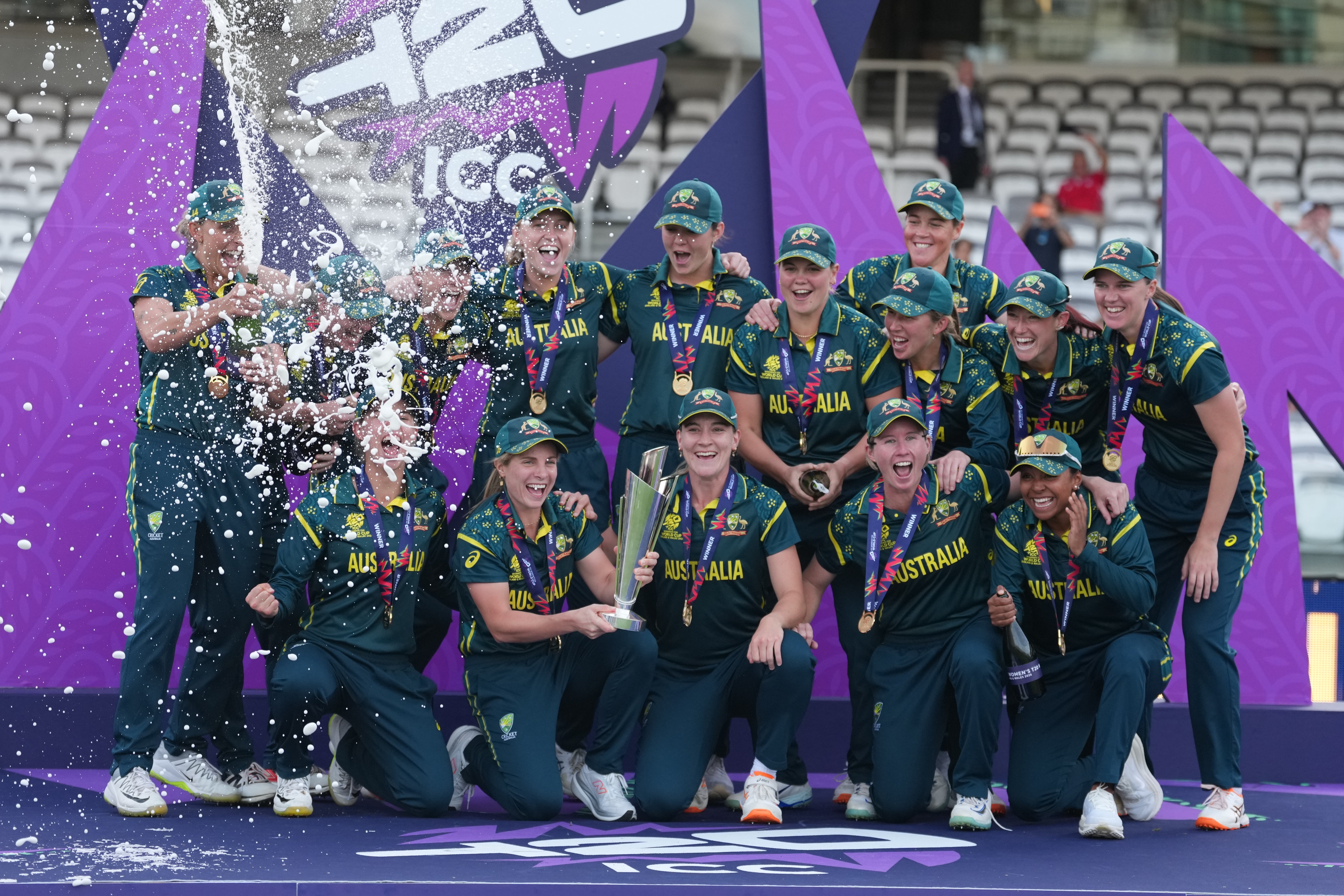 The Australia team celebrate on the podium with the trophy after winning the Women's T20 Cricket World Cup