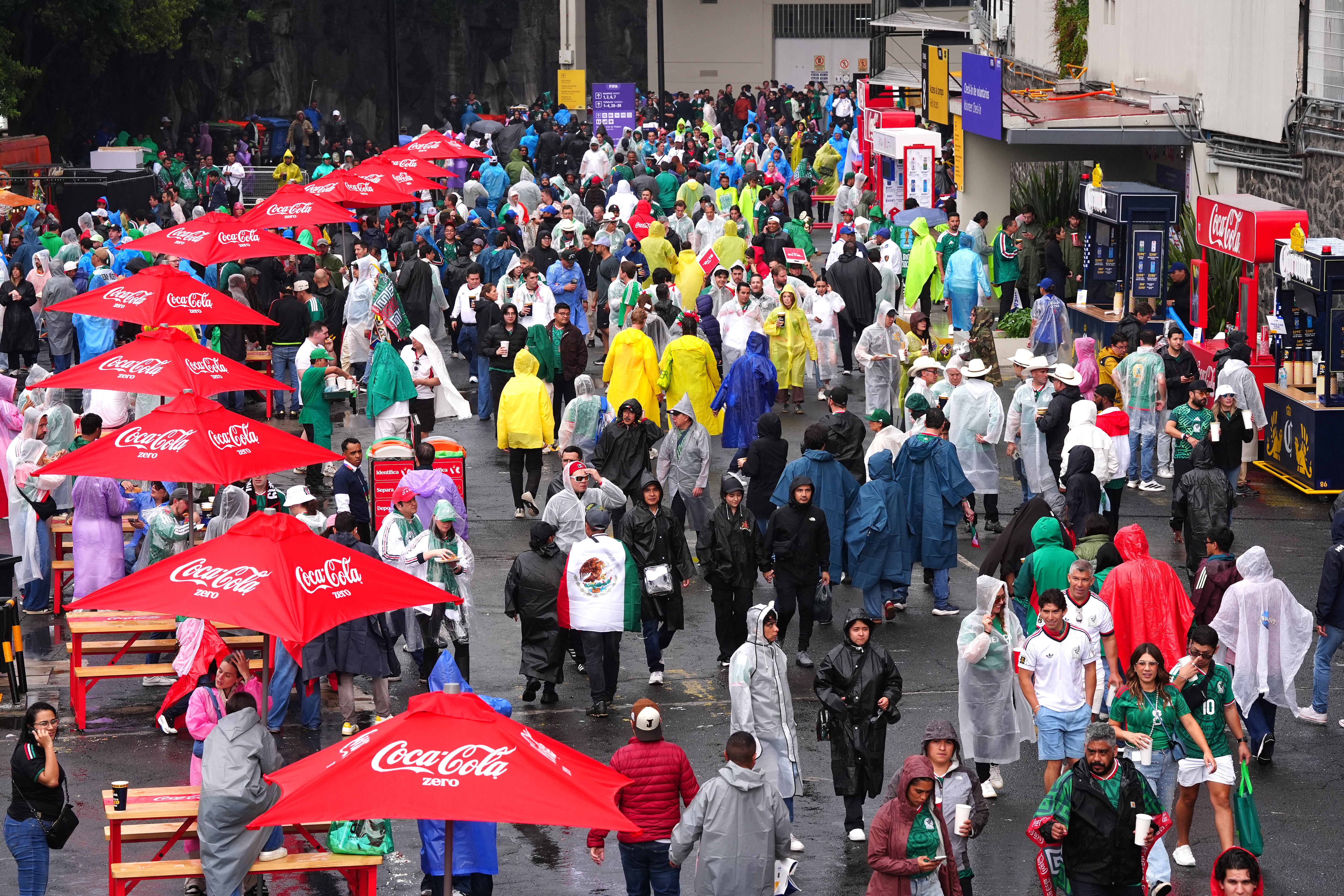 A general view of fans as it rains outside the stadium ahead of the FIFA World Cup Round of 16 match at Mexico City Stadium