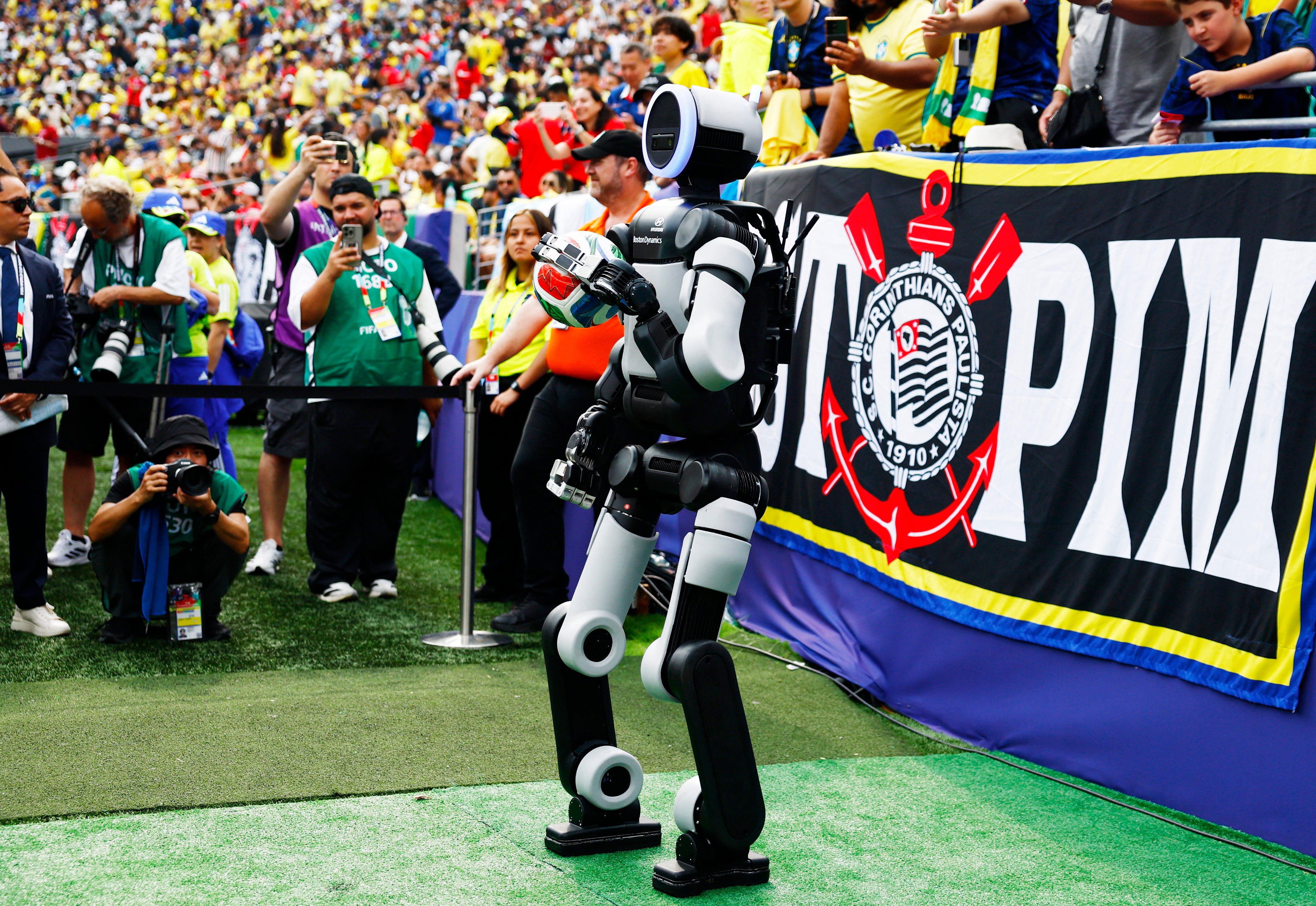 Hyundai robot Atlas brings the match ball out before the second half REUTERS/Jeenah Moon