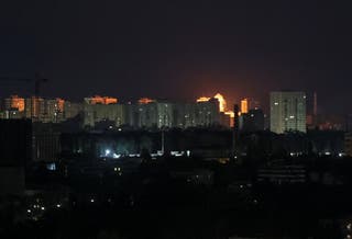 An explosion lights up the sky over the city during a Russian missile and drone strike in Kyiv