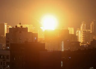 An explosion lights up the sky over the city during a Russian missile and drone strike in Kyiv