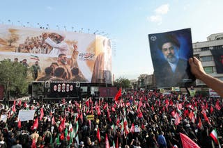 A mourner holds an image of Iran's Supreme Leader Mojtaba Khamenei as people gather for a funeral procession for Iran's late Supreme Leader Ayatollah Ali Khamenei