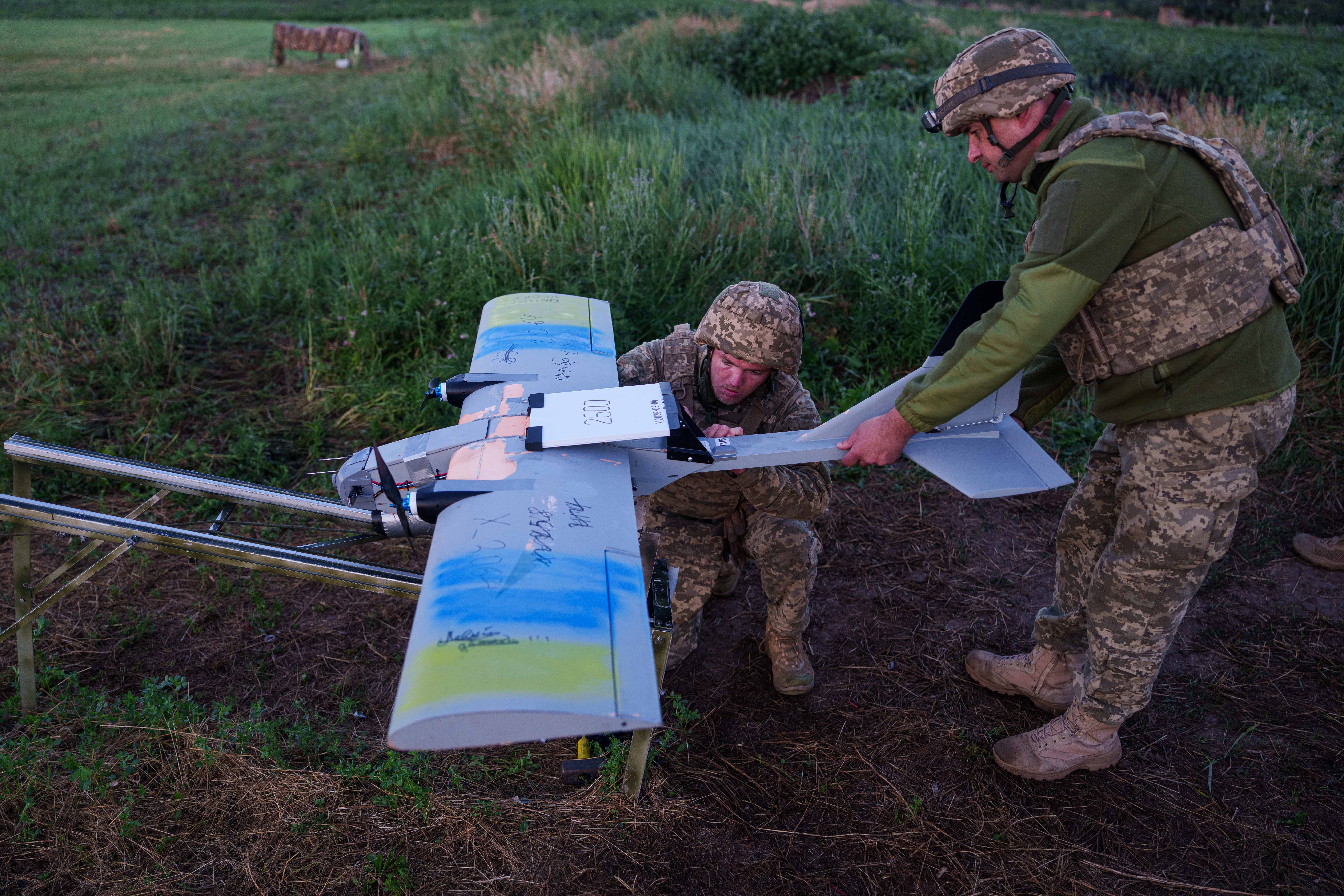 Ukrainian servicemen of K-2 brigade of the Unmanned Systems Forces prepare a midrange drone at takeoff position before flying towards Russian positions at the frontline in Donetsk region, Ukraine, Monday, June 22, 2026. (AP Photo/Evgeniy Maloletka)