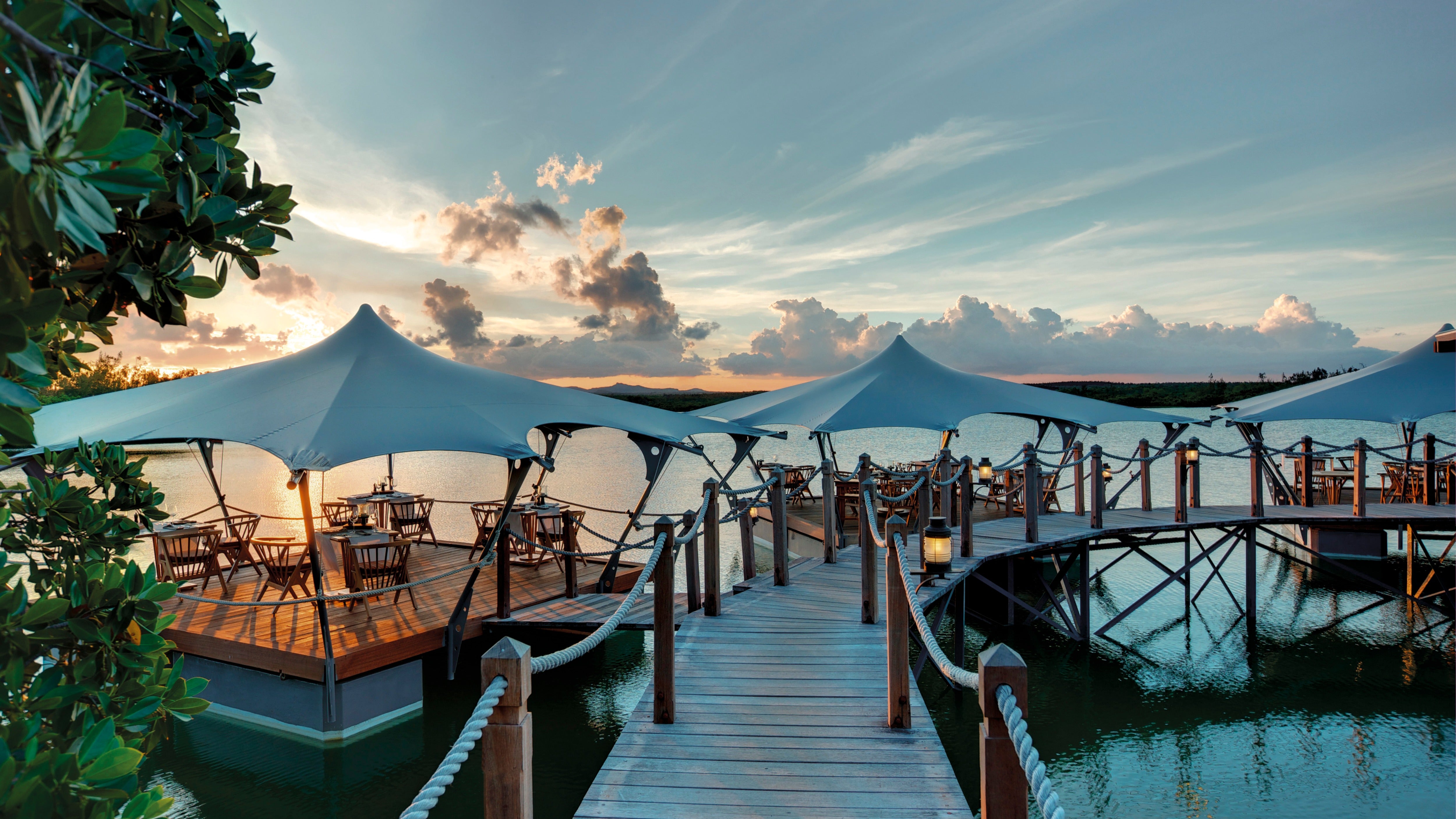 Le Barachois is a floating restaurant lit by lanterns