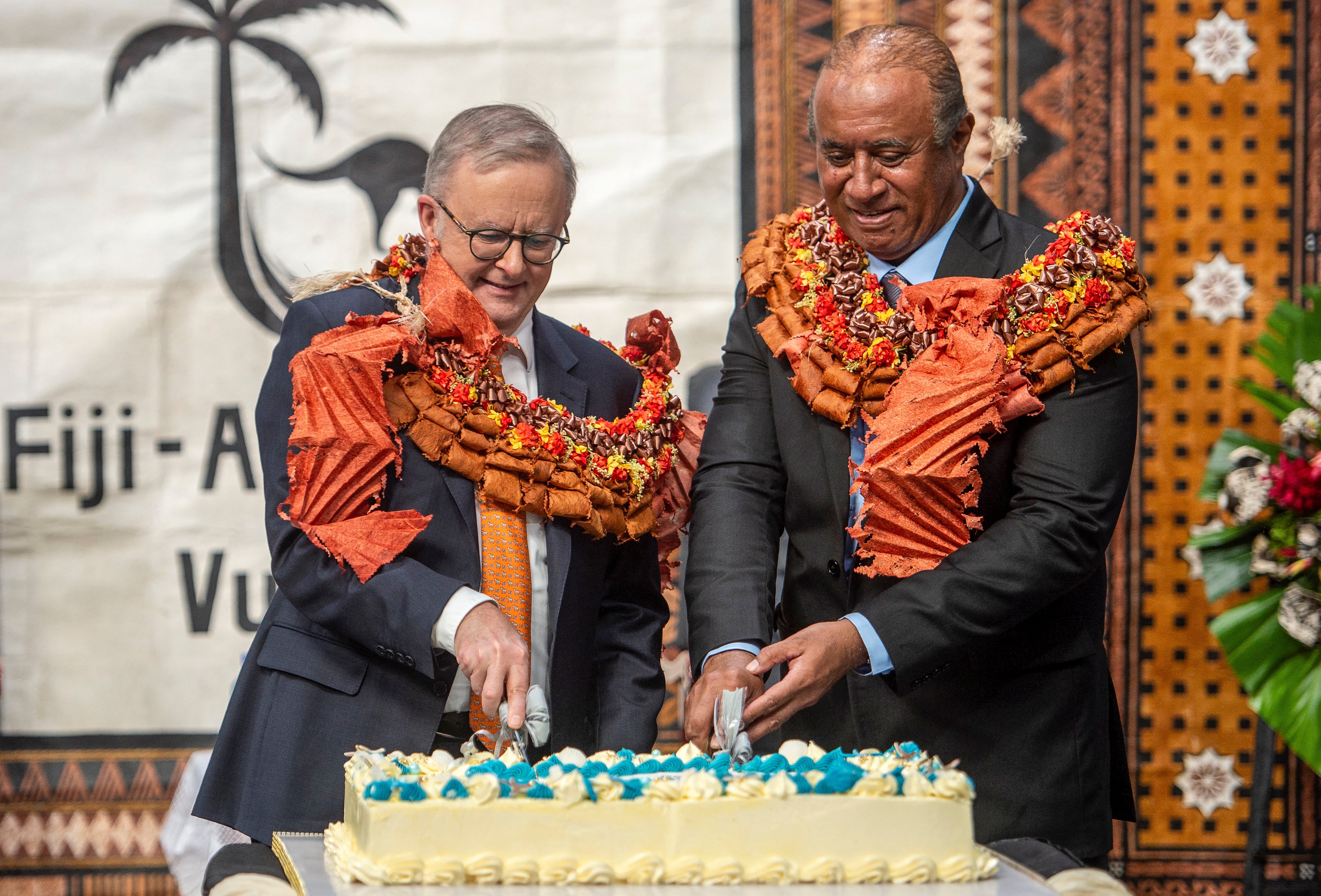 Anthony Albanese and Fiji’s public works minister Ro Filipe Tuisawau cut a cake during the opening of the Vuvale Skills hub in Suva