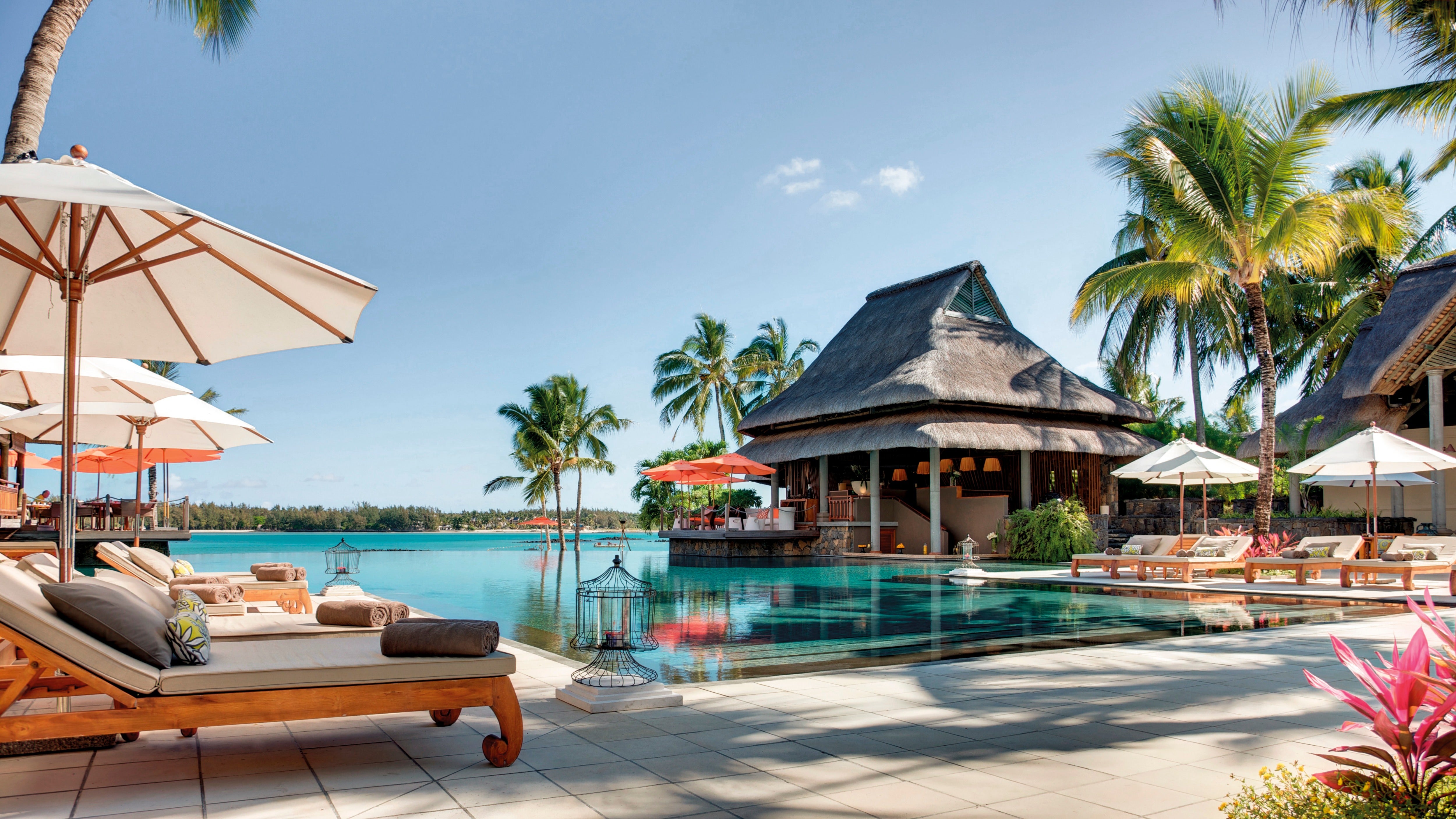 The infinity pool appears to spill over onto the beach