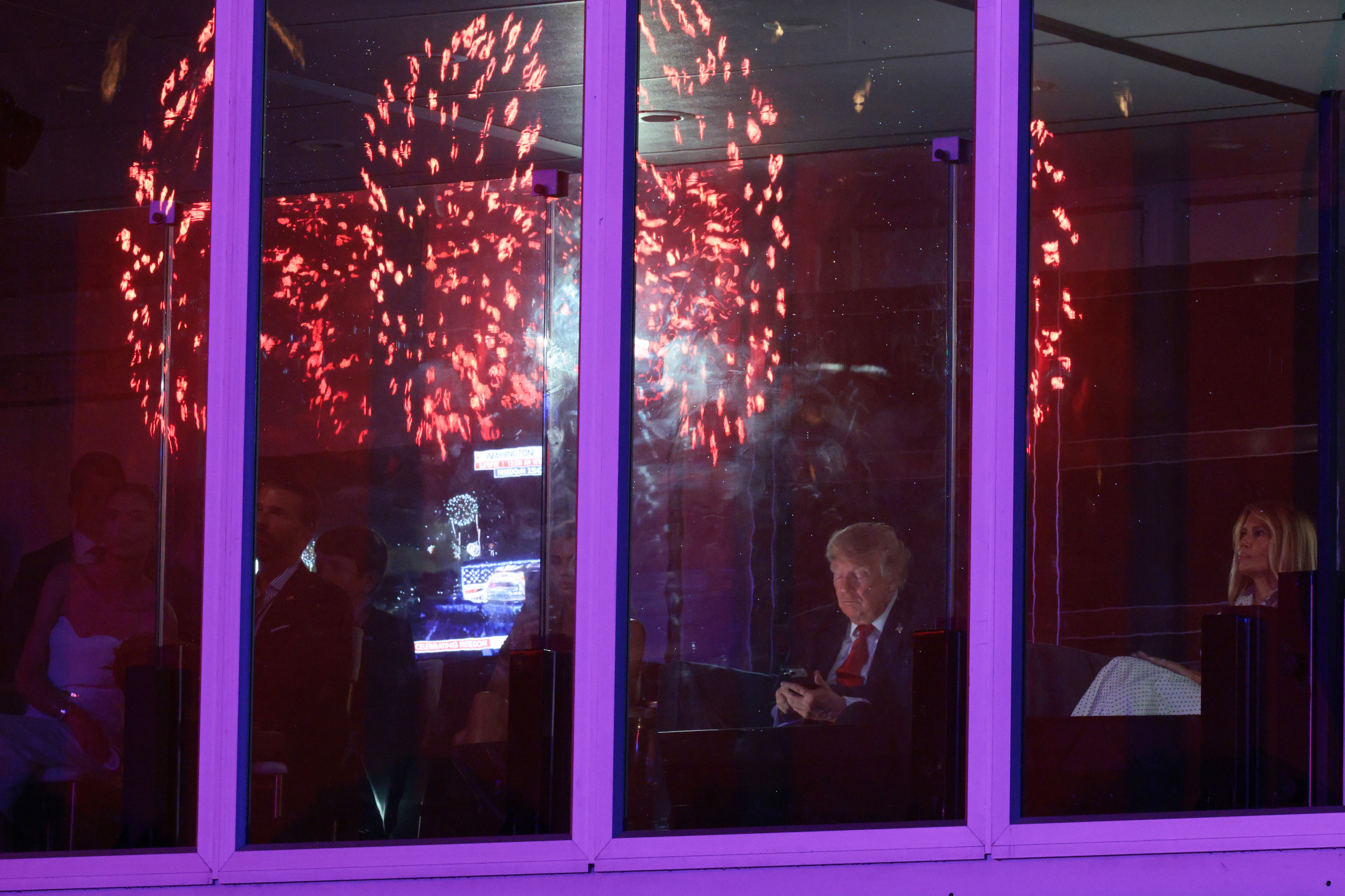 The president and First Lady Melania Trump watched the fireworks on the Mall, which kicked off shortly before midnight, from a sealed off viewing area