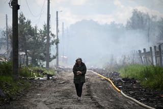 A resident walks on a street at a site of a Russian attack near Kyiv