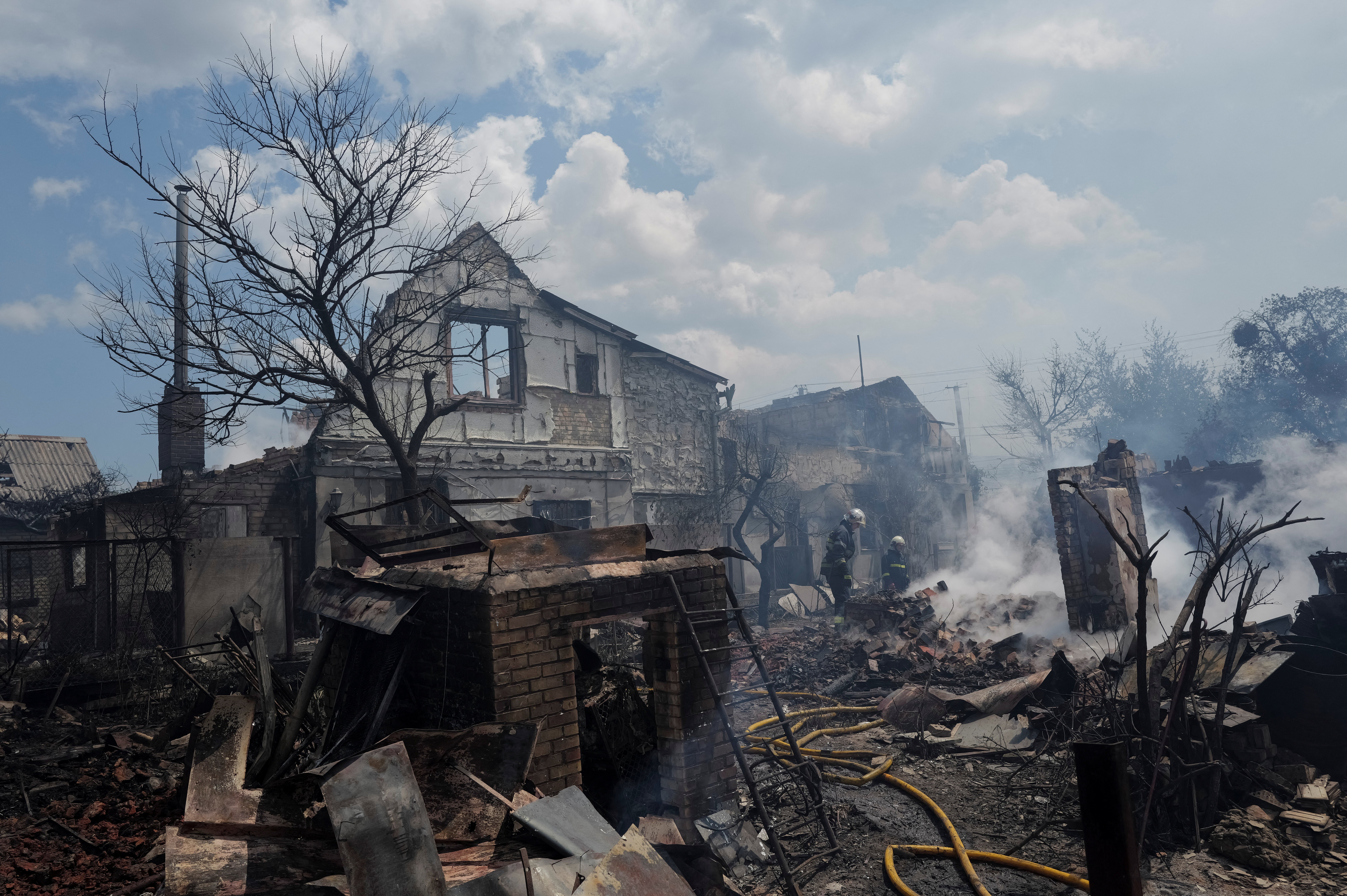 Firefighters work at a site of strikes near Kyiv (Reuters)