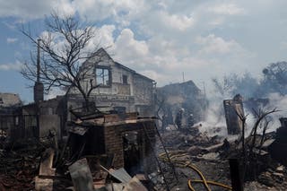 Firefighters work at a site of strikes near Kyiv