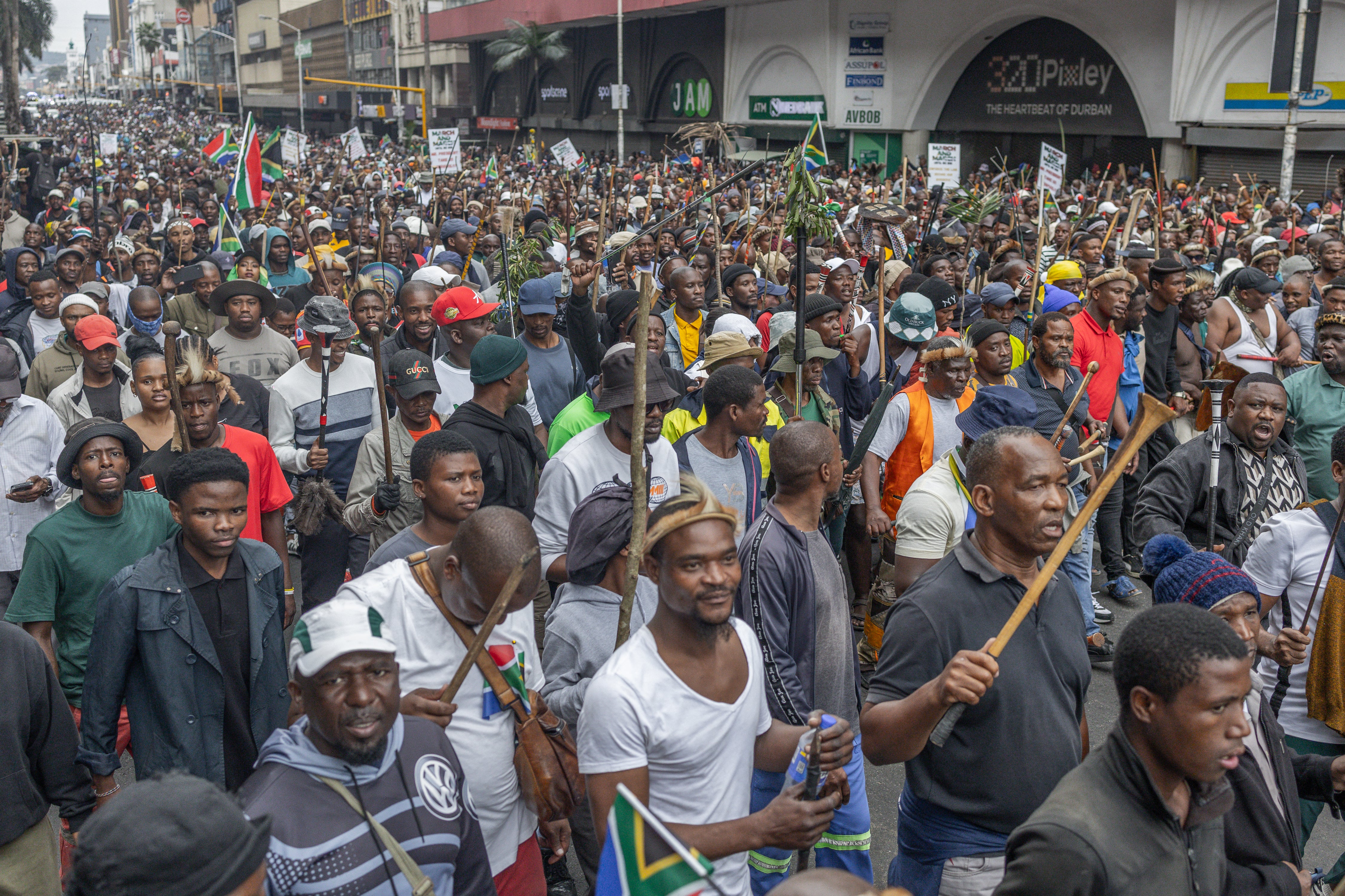 Members of the Zulu regiment known as the 'Amabutho' chant slogans as they march during a demonstration by the "March and March" movement