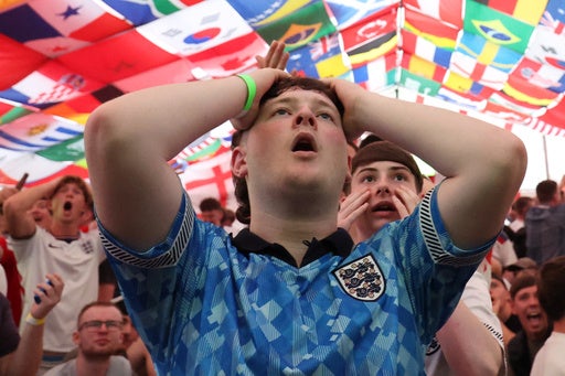 England fans react to the World Cup match between England and Croatia at The Clock pub in Hebburn.