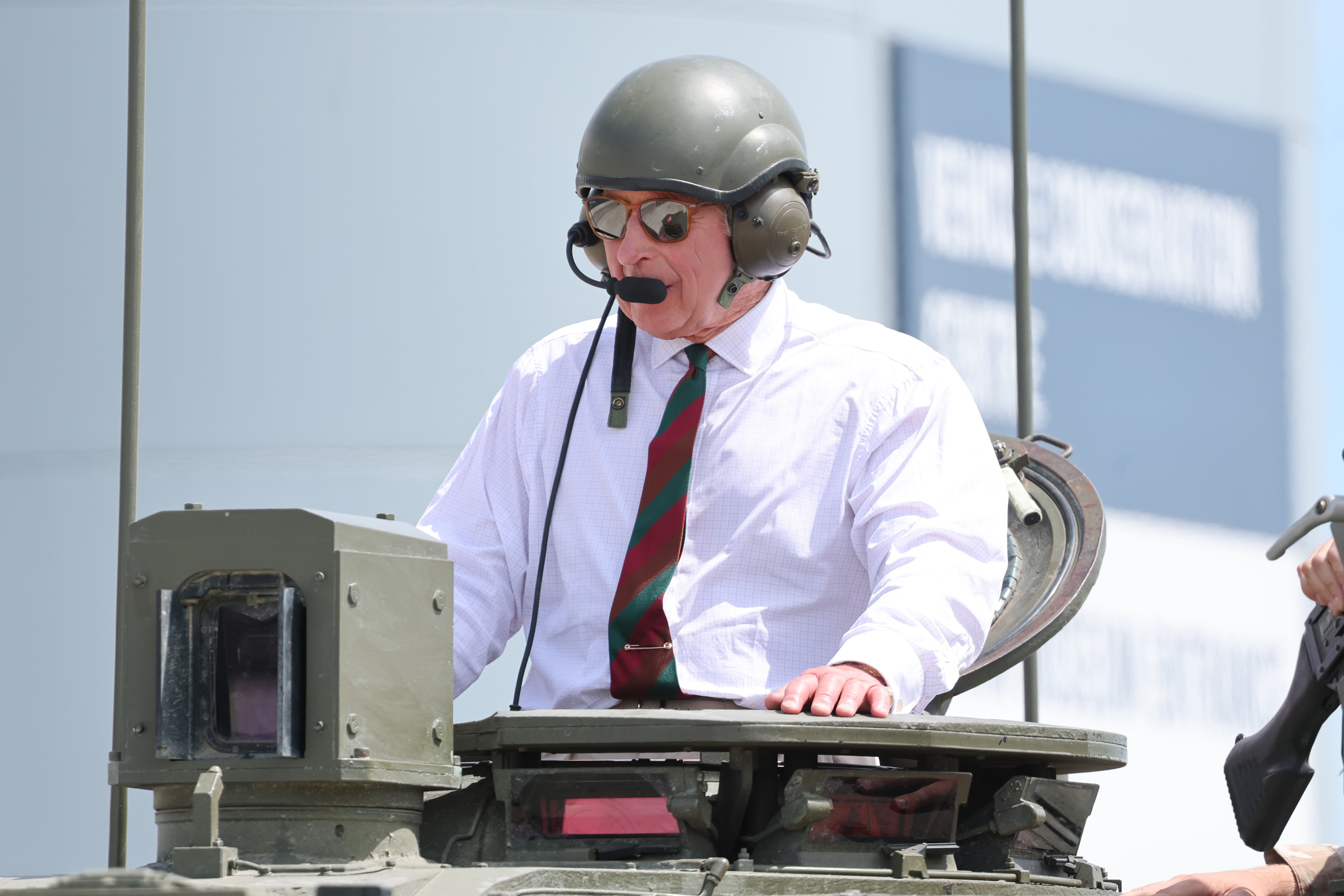 Wearing a crew guard helmet, King Charles, sitting in the commander seat, was then taken for a ride around the museum’s arena in a Challenger 2 tank (PA)