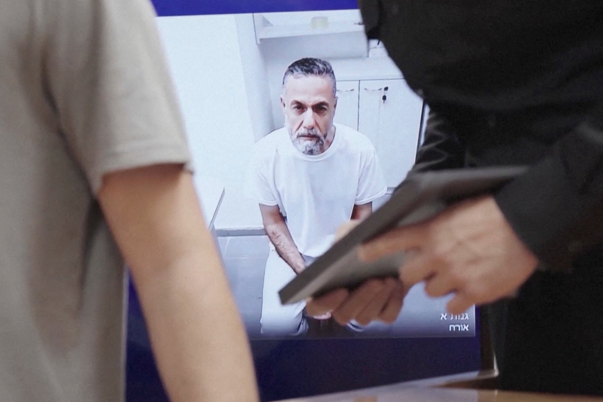 Palestinian doctor Hussam Abu Safiya, who was captured by the Israeli military in Gaza in late 2024 and still held in detention, appears via video link at the Israeli Supreme Court hearing in Jerusalem, June 10, 2026