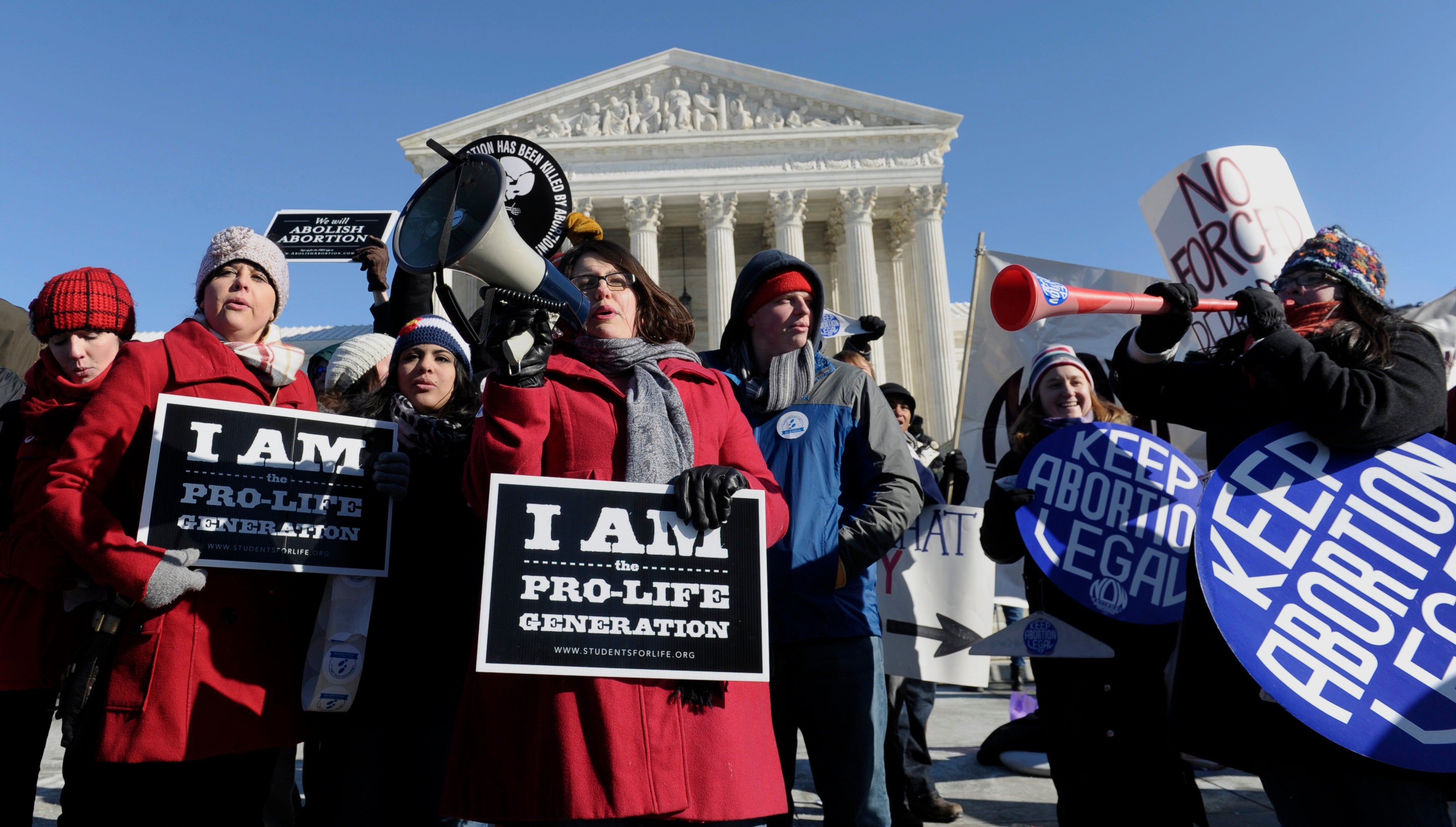 Pro-abortion and anti-abortion protestors rally outside the Supreme Court in Washington