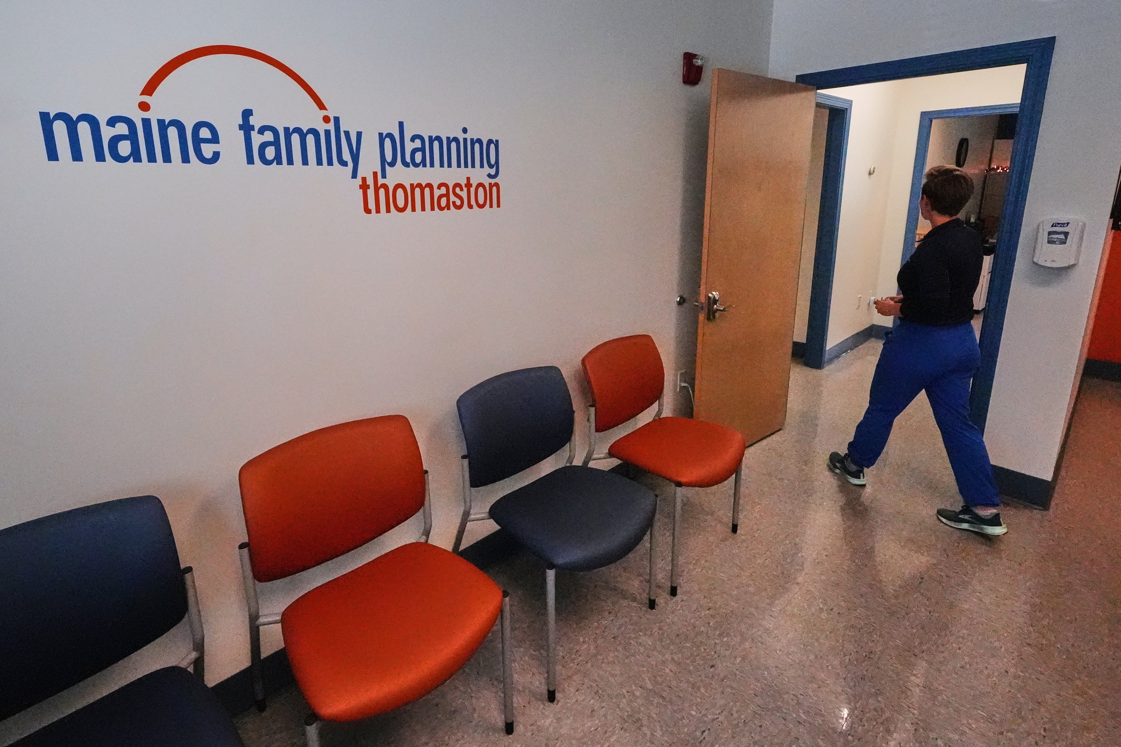 Vanessa Shields-Haas, a nurse practitioner, walks from the lobby toward the examination rooms at the Maine Family Planning healthcare facility