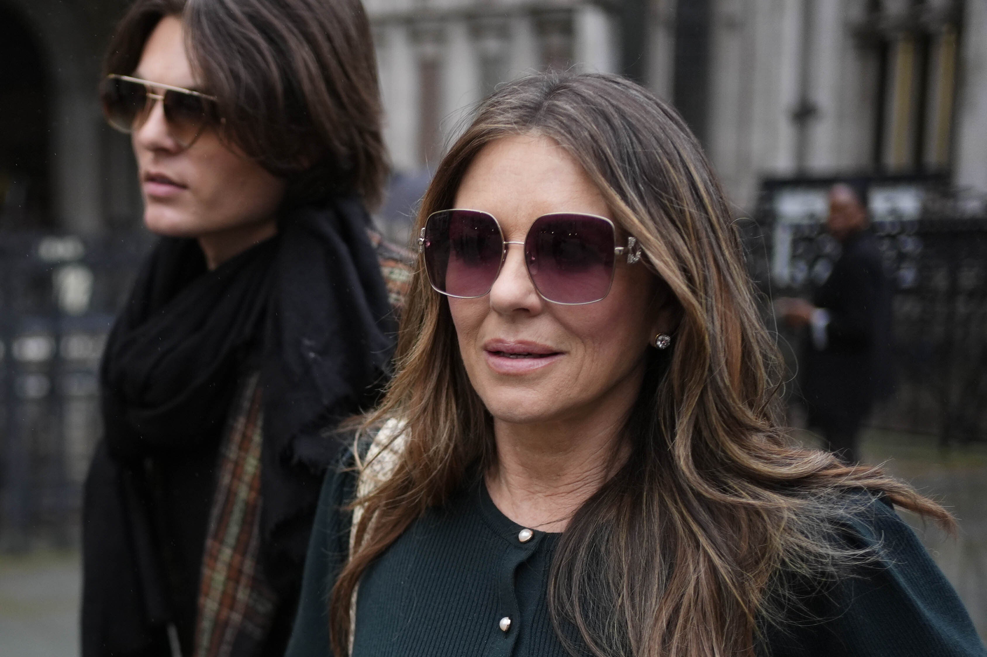 Elizabeth Hurley leaving the Royal Courts of Justice with her son Damian during the trial (Jordan Pettitt/PA) (PA Wire)