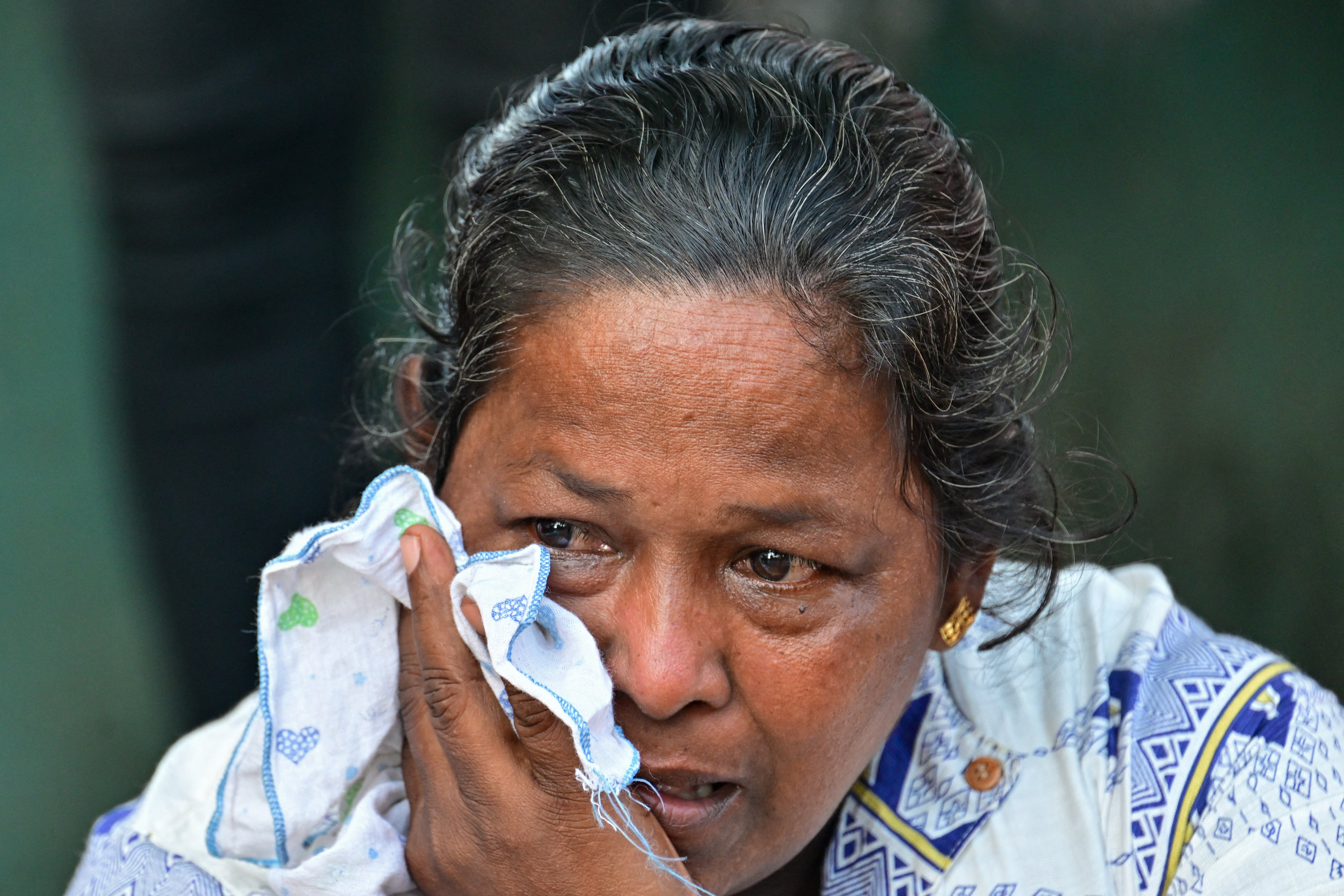 A relative of a victim killed in overnight clashes between inmates of two drug gangs, grieves in front of the Negombo prison on the outskirts of Colombo