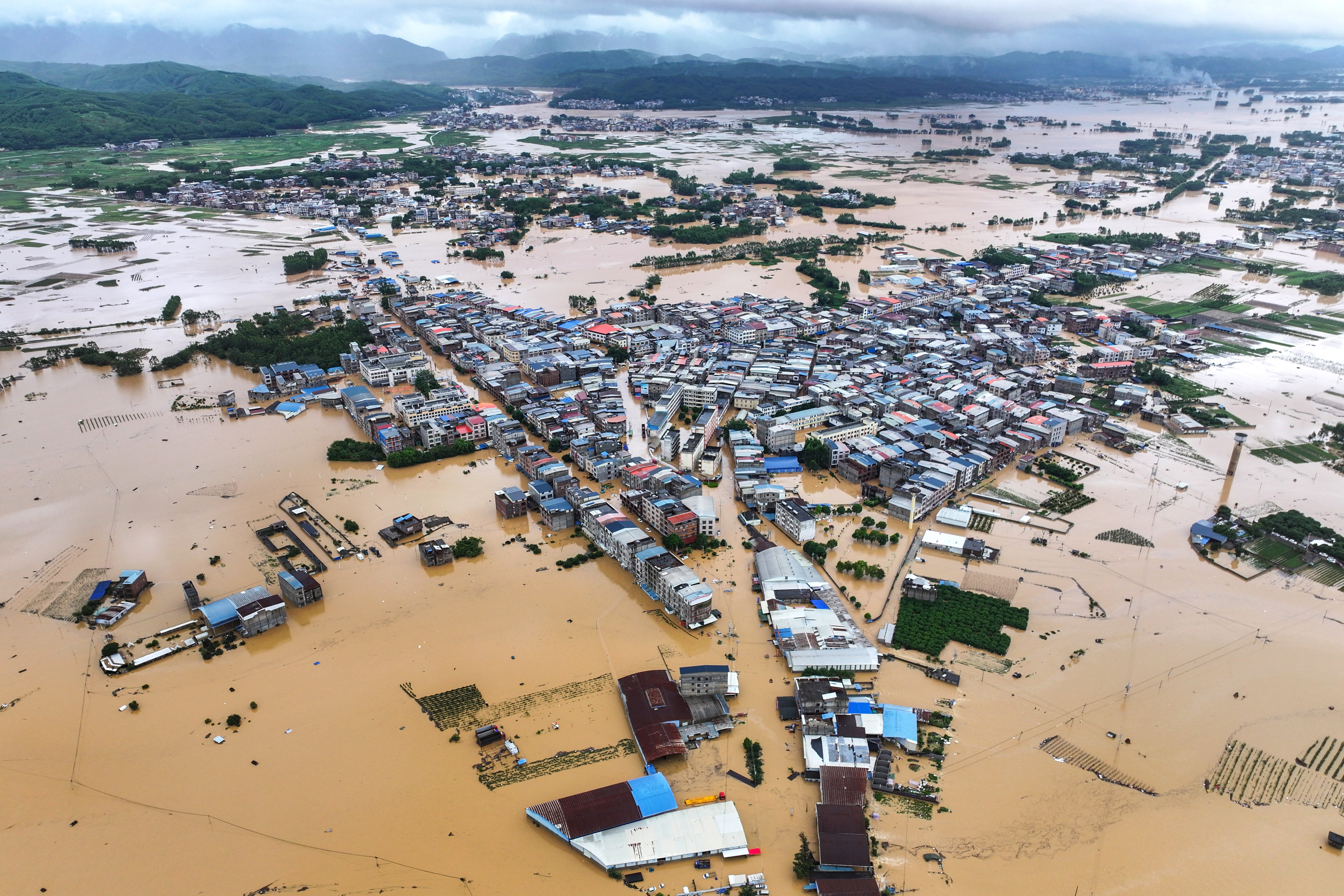 A breach in the Liulan reservoir floods downstream areas in Hengzhou, Nanning, China