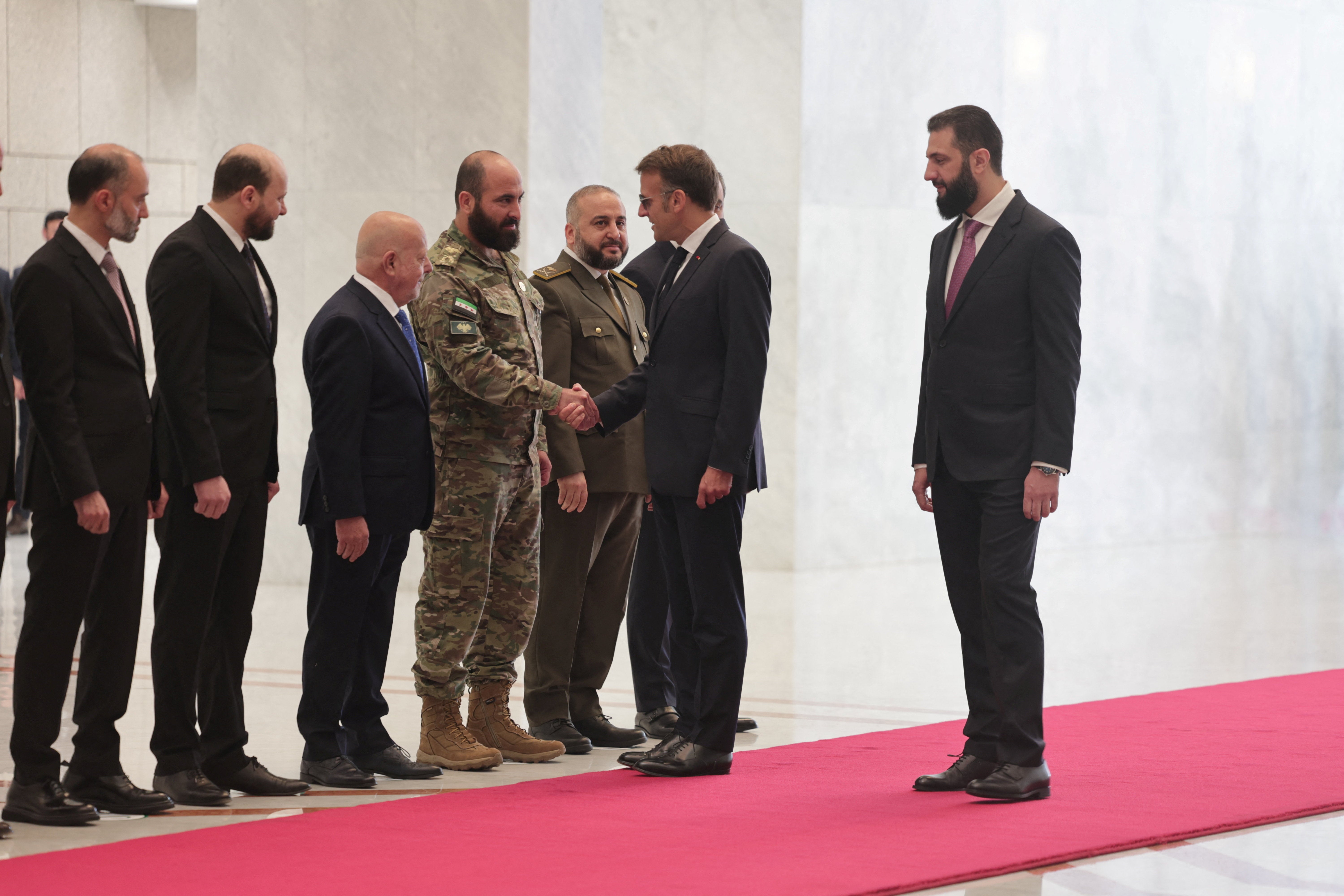France's President Emmanuel Macron meets a delegation as Syrian President Ahmed Al-Sharaa receives Macron at the People's Palace in Damascus (Reuters)