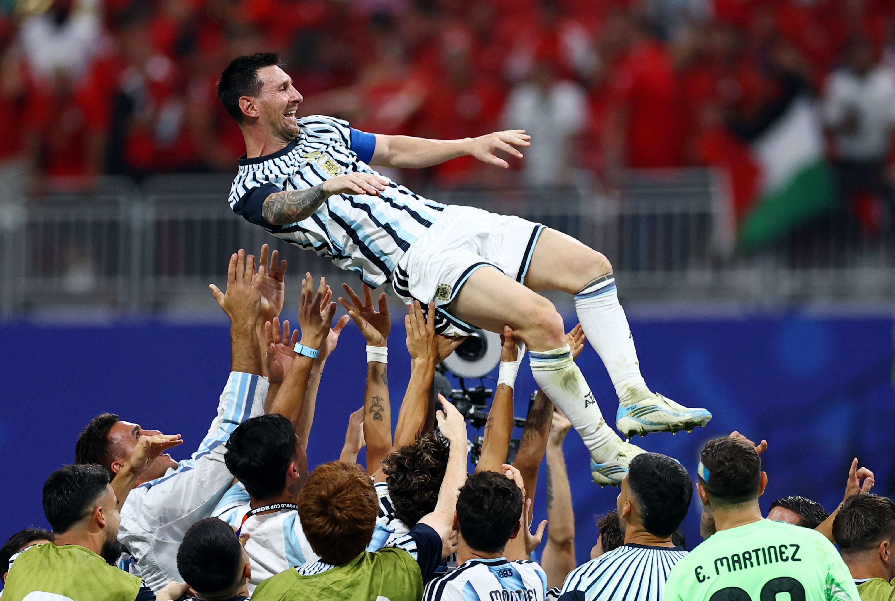 by joy as his teammates tossed him into the air