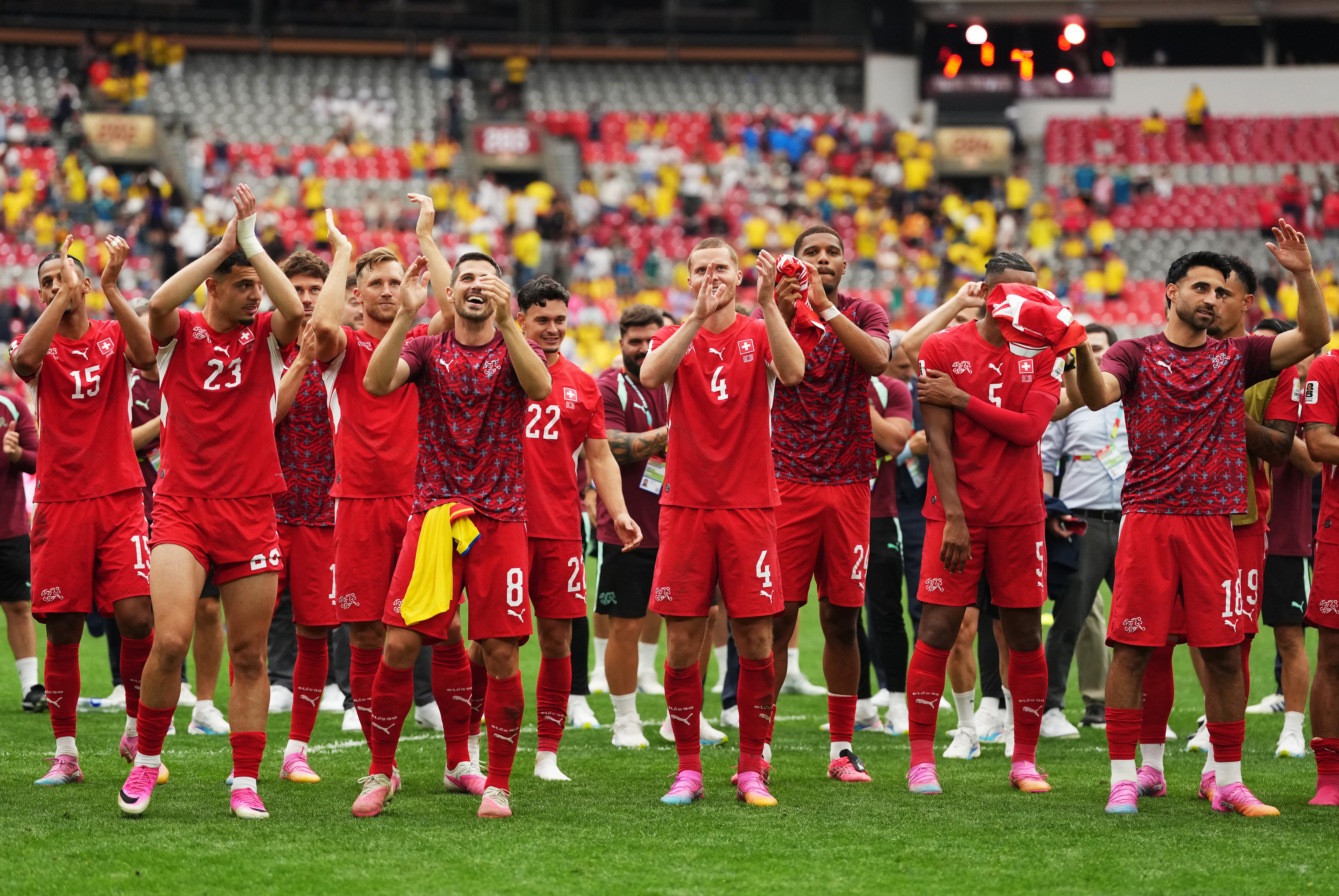 Switzerland players salute supporers after winning in a penalty kick shootout
