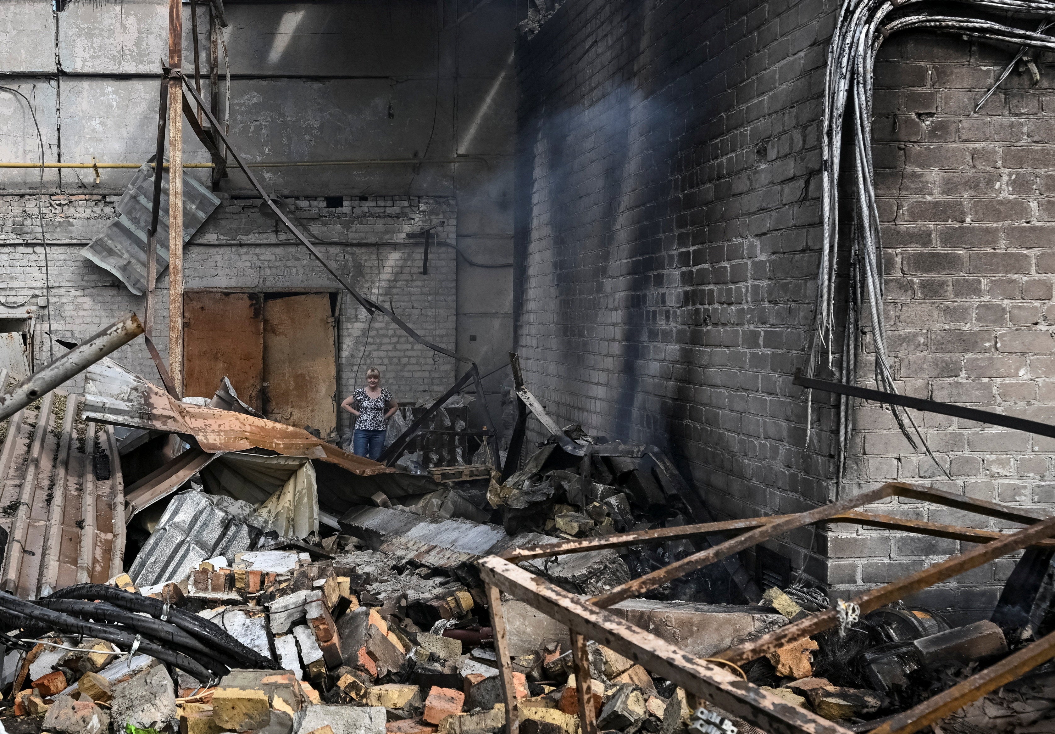 A resident stands at a site of a Russian air strike, amid Russia's attack on Ukraine, in Zaporizhzhia, Ukraine July 8, 2026. (Reuters)