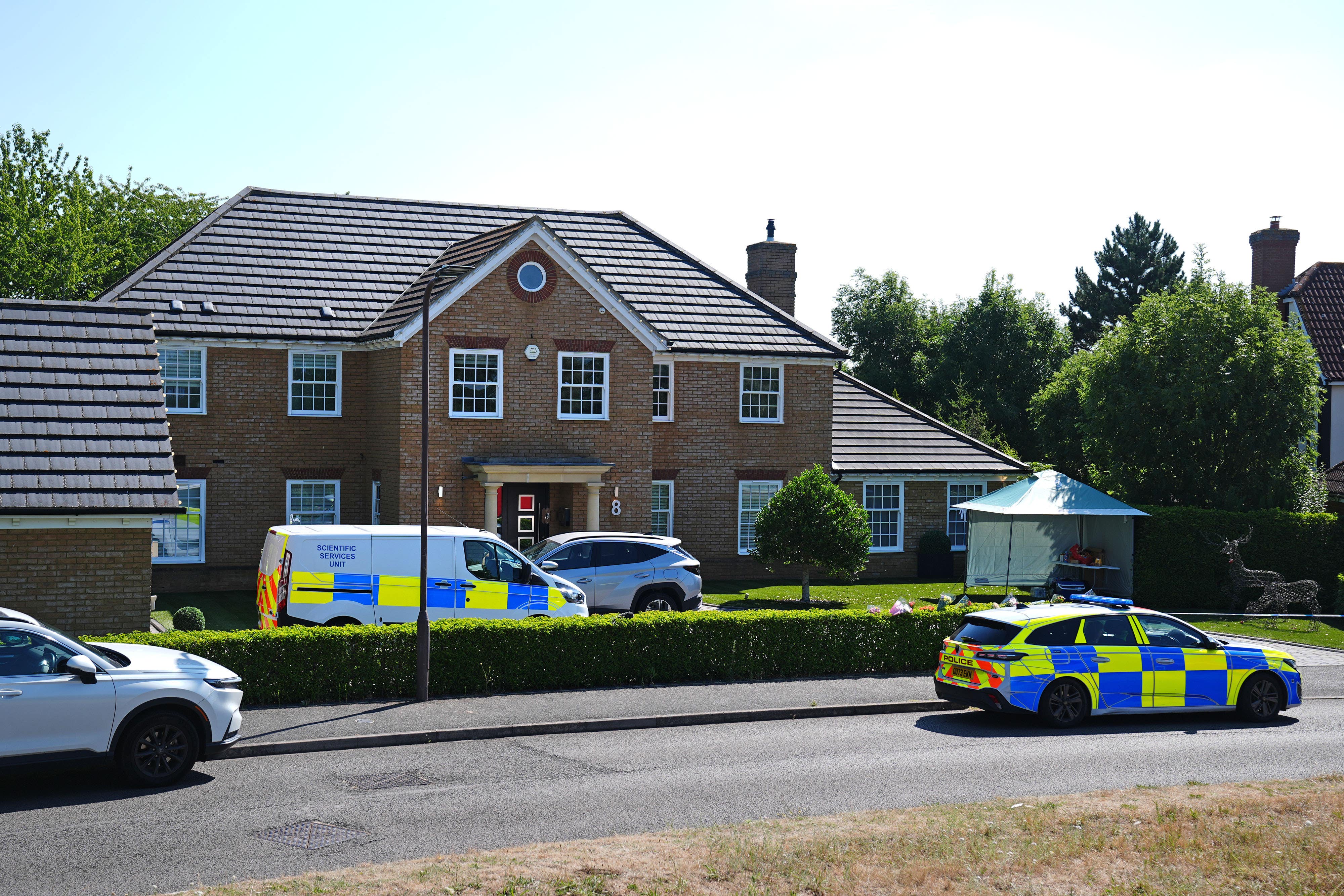 Police outside the house on Carnoustie Drive, Great Denham, near Bedford (Jacob King/PA)