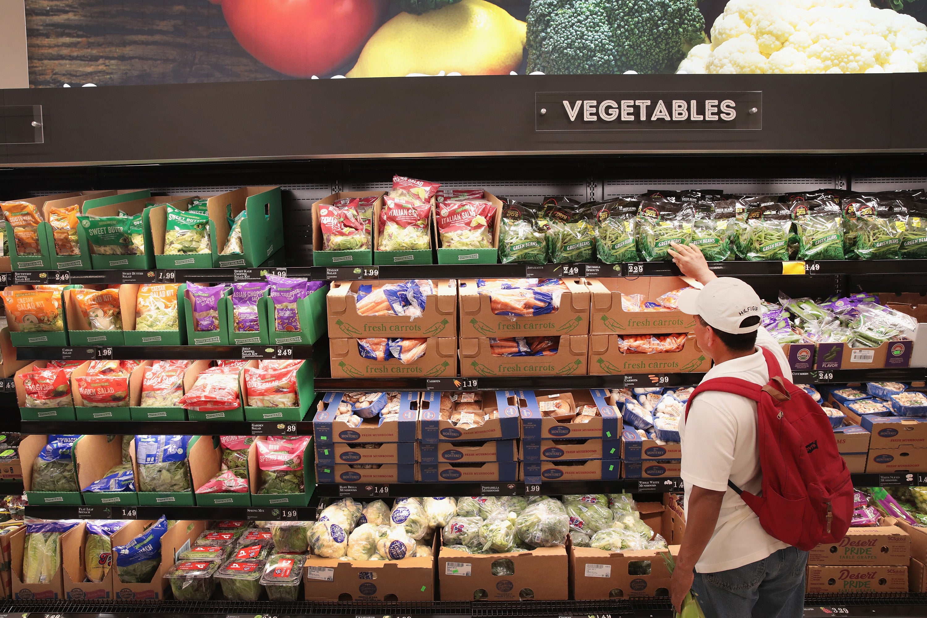 A customer shops for bagged lettuce at a grocery store in Chicago, Illinois, in June 2017. Bagged lettuce and other produce is tied to the spread of cyclospora