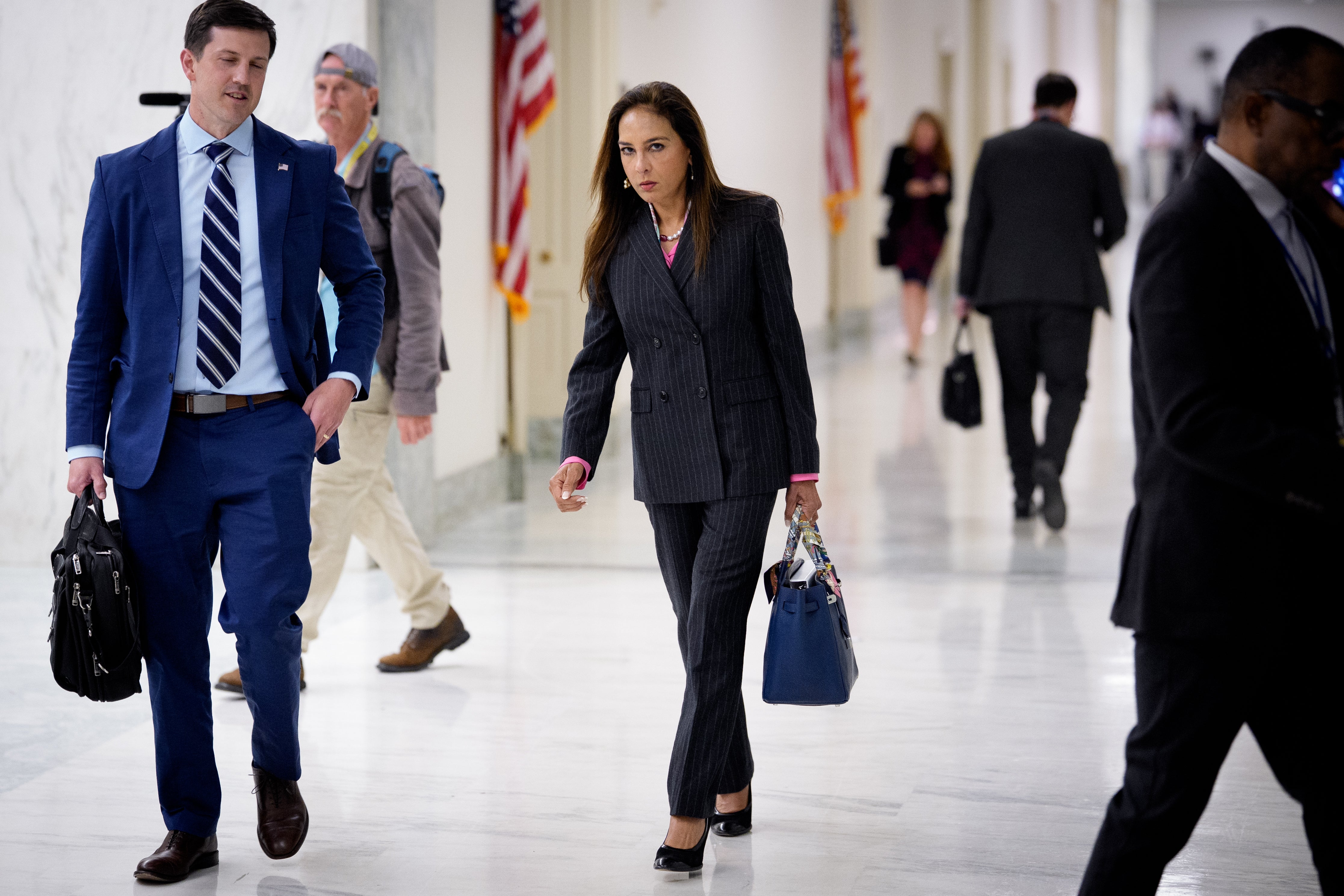 Harmeet Dhillon, the assistant attorney general for civil rights, (pictured center) sent letters threatening criminal action against state election officials if they knowingly permit non-citizens to vote
